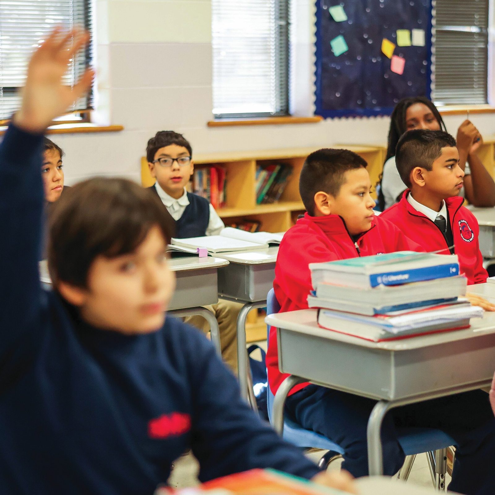 Thiago Almidon, a sixth grader at St. Martin of Tours School in Gaithersburg, Maryland, raises his hand in class. (Catholic Standard photo by Andrew Biraj)