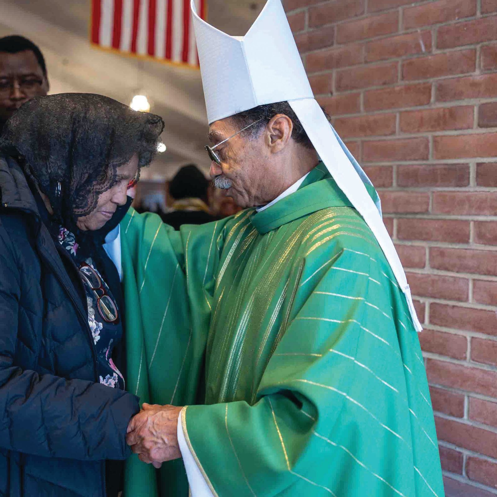 Washington Auxiliary Bishop Roy E. Campbell Jr. blesses a woman after concelebrating a Jan. 18 Mass at Shrine of St. Jude Catholic Church in Rockville, Maryland that he offered in remembrance of the legacy of the Rev. Dr. Martin Luther King Jr. More than 500 people attended the annual celebration of the legacy of the late civil rights leader. (Catholic Standard photo by Mihoko Owada)