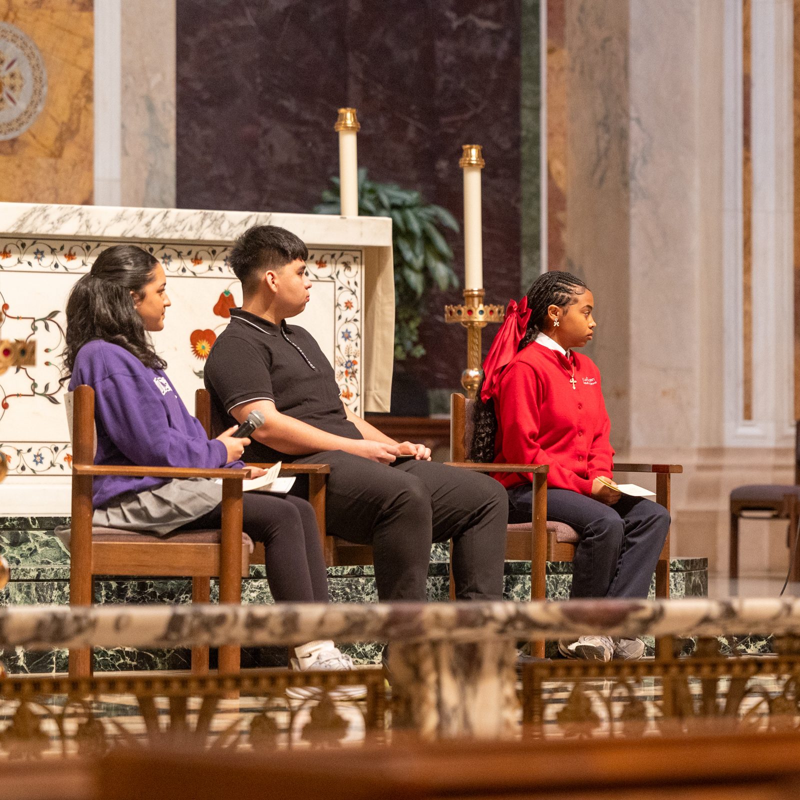 Before the Youth Mass for Life on Jan. 24, 2025 at the Cathedral of St. Matthew the Apostle in Washington, Cardinal Wilton Gregory held a question-and-answer session with youth. The students joining him were, from left to right, Andrea Patino, a 10th grader at The Academy of the Holy Cross in Kensington, Maryland; Erik Lopez Rivas, an 11th grader at Don Bosco Cristo Rey High School in Takoma Park, Maryland; and Alivia Wade, an eighth grader at St. Anthony Catholic School in Washington, D.C. (Catholic Standard photo by Mihoko Owada)