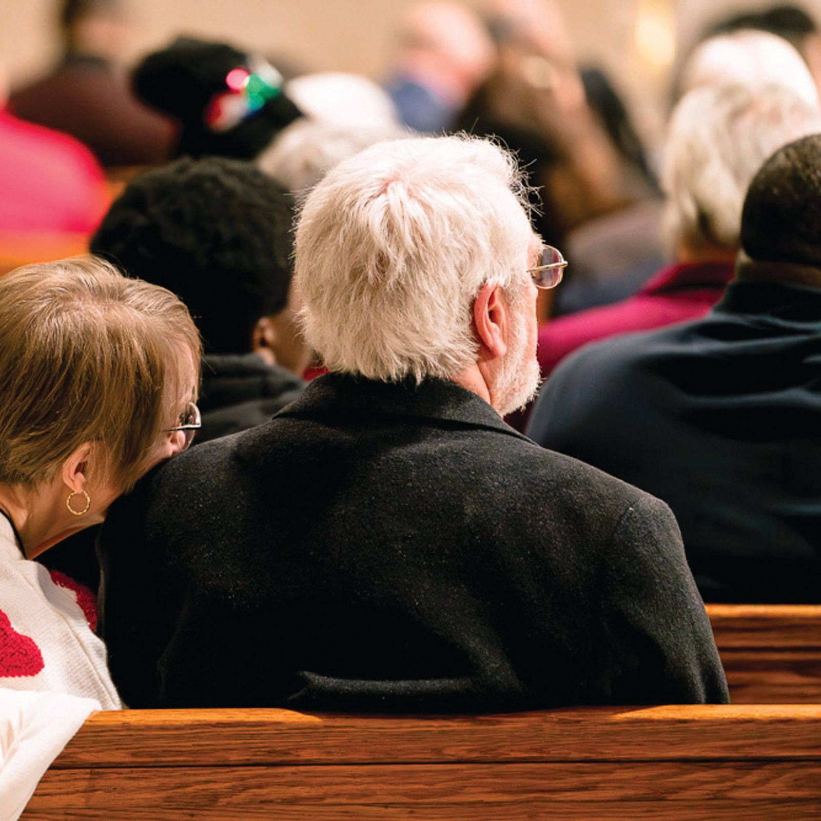 A woman rests her head on her husband’s shoulder during the annual Wedding Anniversary Mass celebrating the vocation of marriage at the Basilica of the National Shrine of the Immaculate Conception on Feb. 14. (Catholic Standard photo by Denniss Olea)