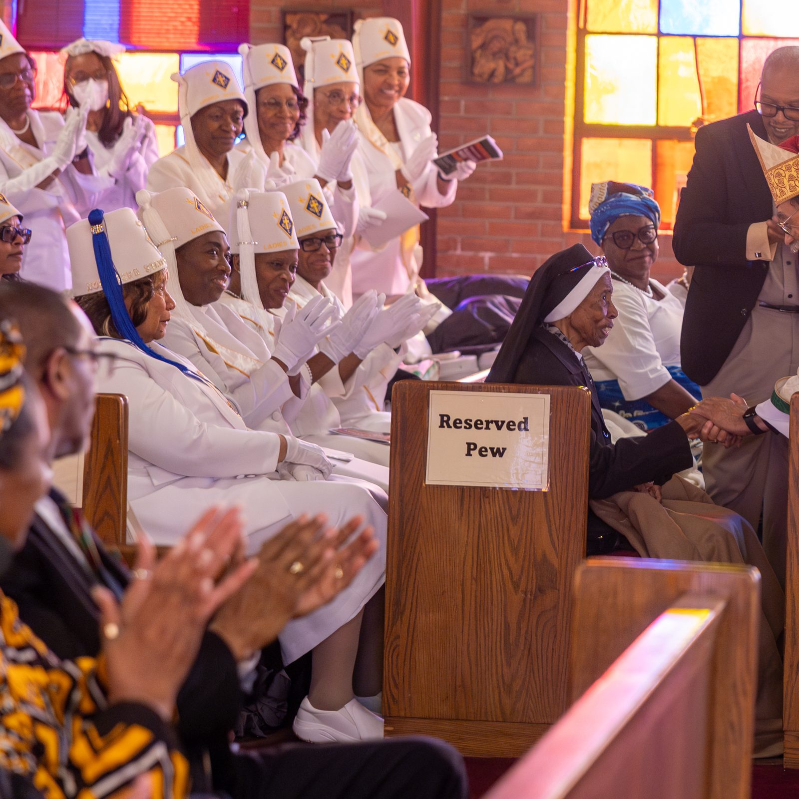 Washington Auxiliary Bishop Roy Campbell Jr. greets Sister Magdala Marie Gilbert, an Oblate Sister of Providence, during a Mass at the Church of the Incarnation in Washington, D.C., on Feb. 22, 2025 marking Black History Month. The annual Mass is sponsored by the Office of Cultural Diversity and Outreach of The Roman Catholic Archdiocese of Washington. (Catholic Standard photo by Mihoko Owada)