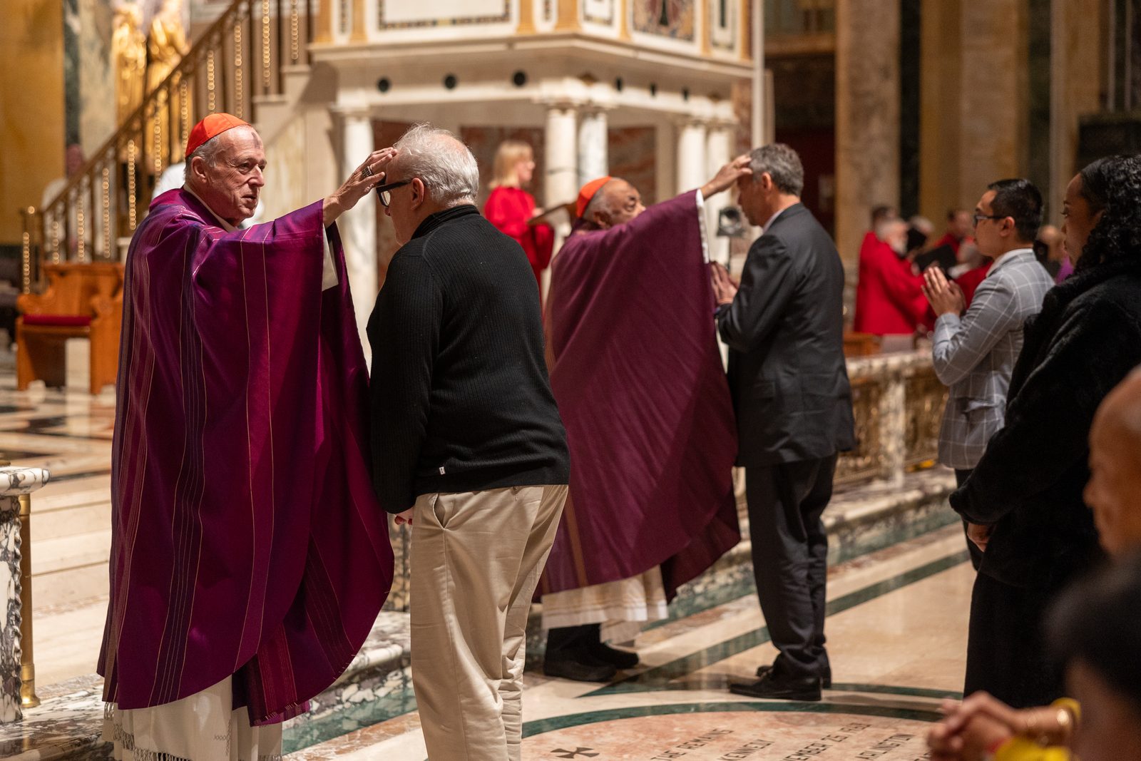 Cardinal Robert McElroy (at left) and Cardinal Wilton Gregory dispense ashes during a March 5 Ash Wednesday Mass at the Cathedral of St. Matthew the Apostle. (Catholic Standard Photo by Mihoko Owada)