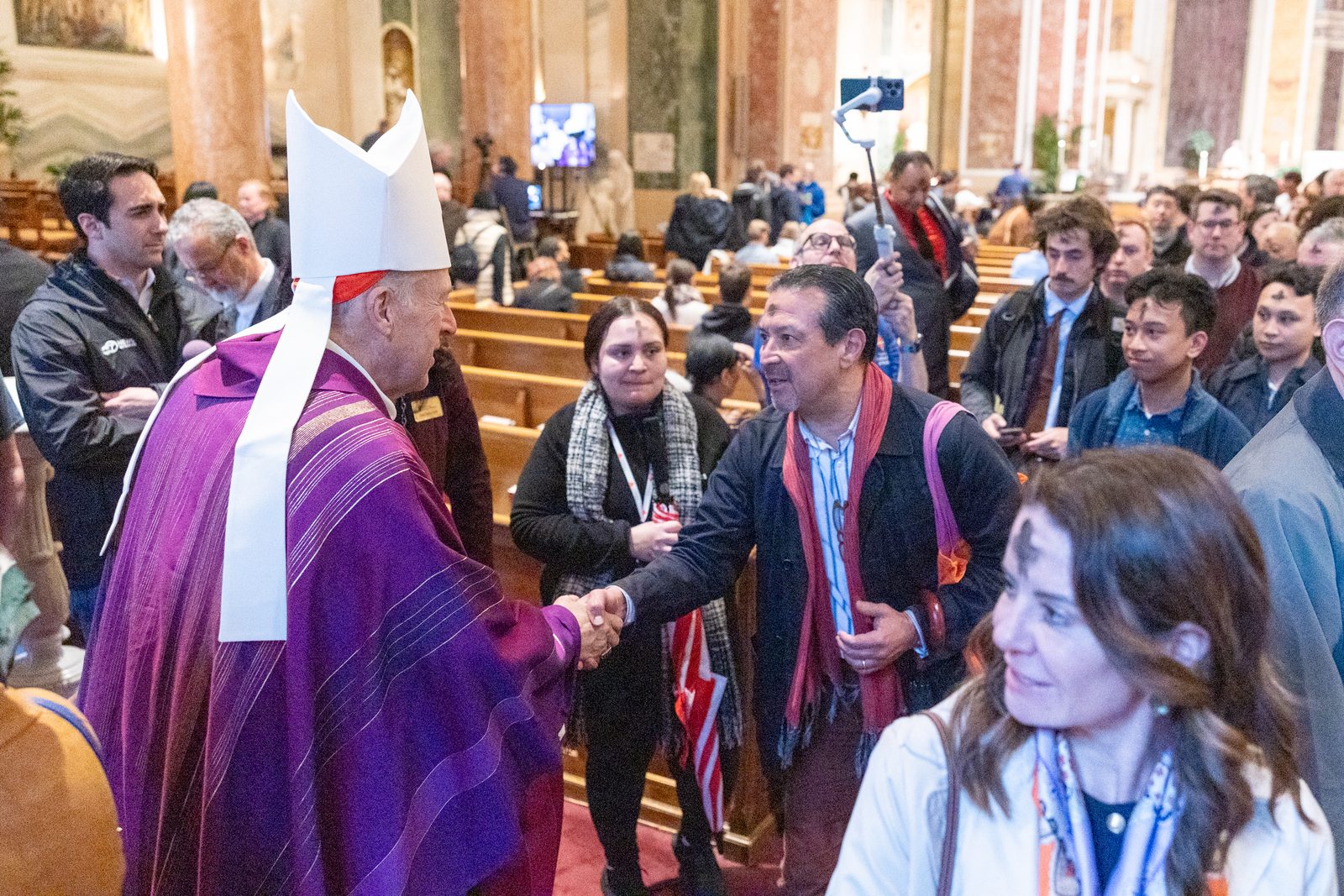 Cardinal Robert McElroy greets the faithful after celebrating a March 5 Ash Wednesday Mass at the Cathedral of St. Matthew the Apostle. About 1,000 people attended the Mass. (Catholic Standard Photo by Mihoko Owada)