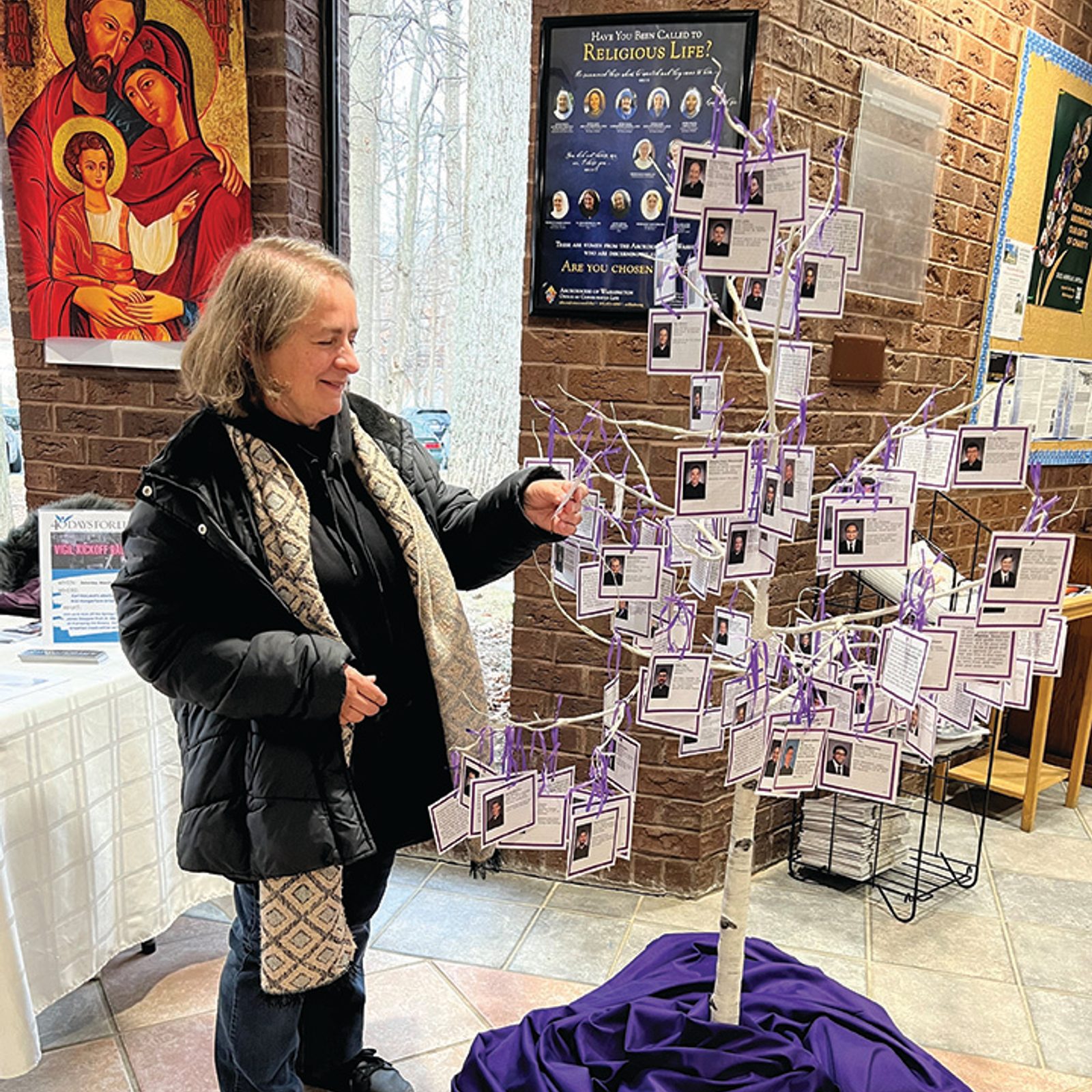 A parishioner arranges the Vocations Tree display at St. John Neumann Church in Gaithersburg, Maryland. (Photo courtesy of Marybeth de Ribeaux)