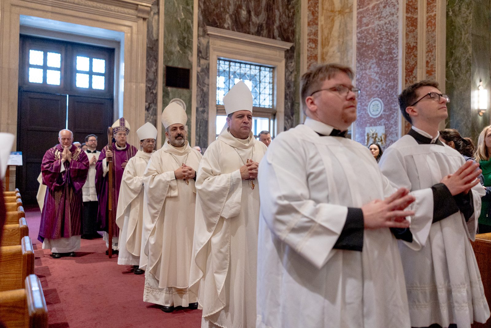 The opening procession for Cardinal Robert W. McElroy’s Mass on March 16, 2025 at the Cathedral of St. Matthew the Apostle included, from right to left, Washington Auxiliary Bishops Evelio Menjivar, Juan Esposito and Roy Campbell Jr., followed by the cardinal. Behind Cardinal McElroy is Father Kevin Regan, his priest secretary, and at left in the background is Deacon Robert Vince. Cardinal McElroy, the new archbishop of Washington, was welcomed to his cathedral church at the Mass. (Catholic Standard photo by Mihoko Owada)