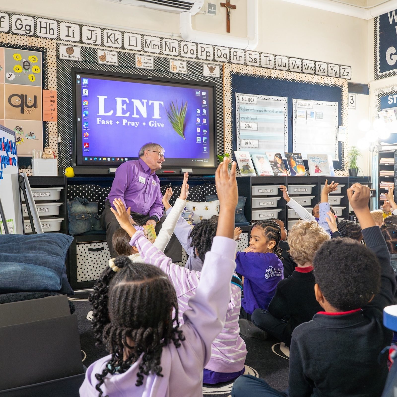 Dr. Dennis Dulniak, president of Nana’s Books Foundation, answers questions from first grade students at St. Anthony Catholic School in Washington, D.C., during an April 7 visit to donate more than 600 books focused on Alzheimer’s, dementia and other disabilities. (Catholic Standard photo by Nicole Olea)
