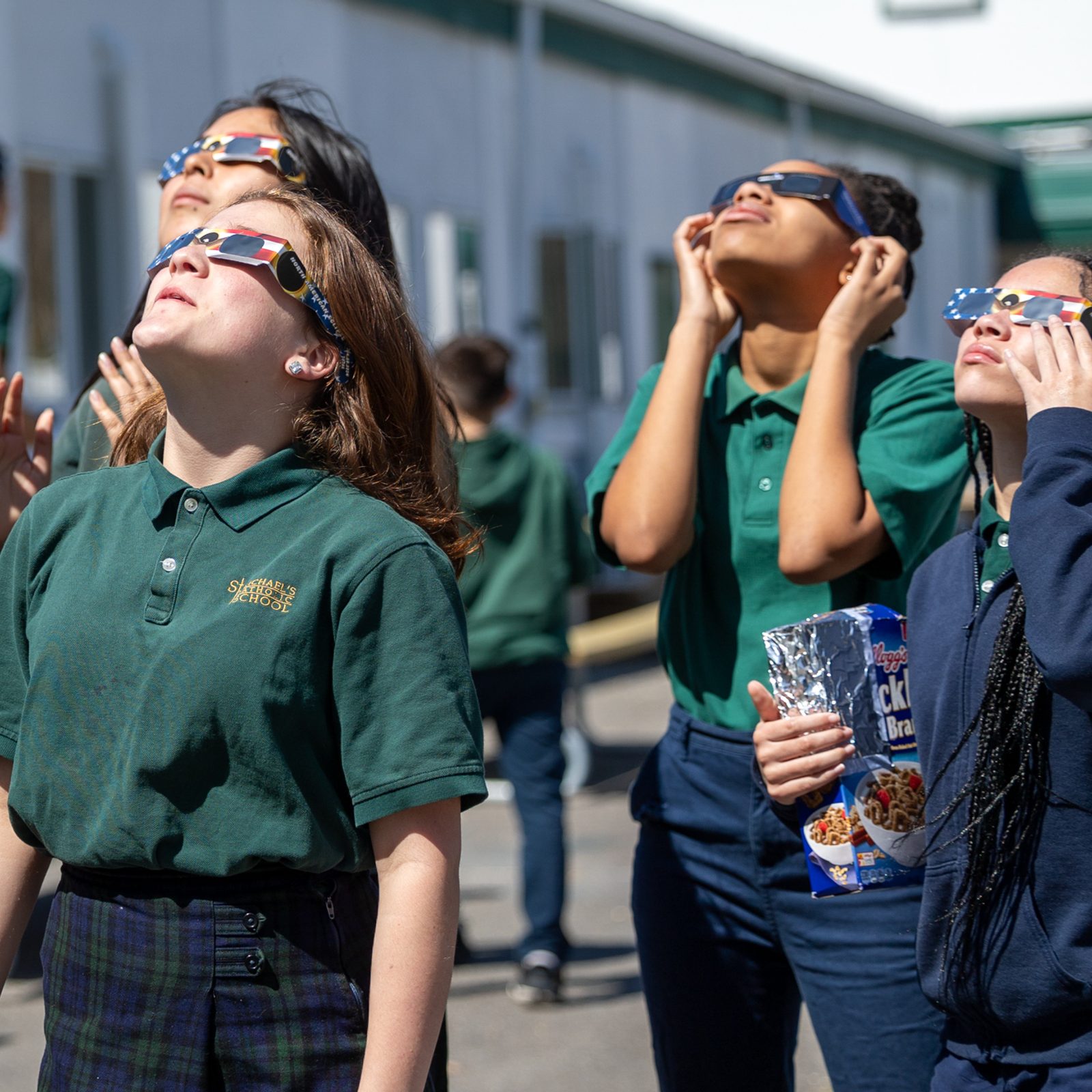 Students at St. Michael’s Catholic School in Ridge had a very special after-school activity on April 8, as they wore protective glasses and viewed the solar eclipse, led by their pastor, Father Peter Giovanoni, who earned degrees in astronomy before entering the priesthood. He viewed the eclipse through his telescope that had a solar filter. (Catholic Standard photos by Mihoko Owada)