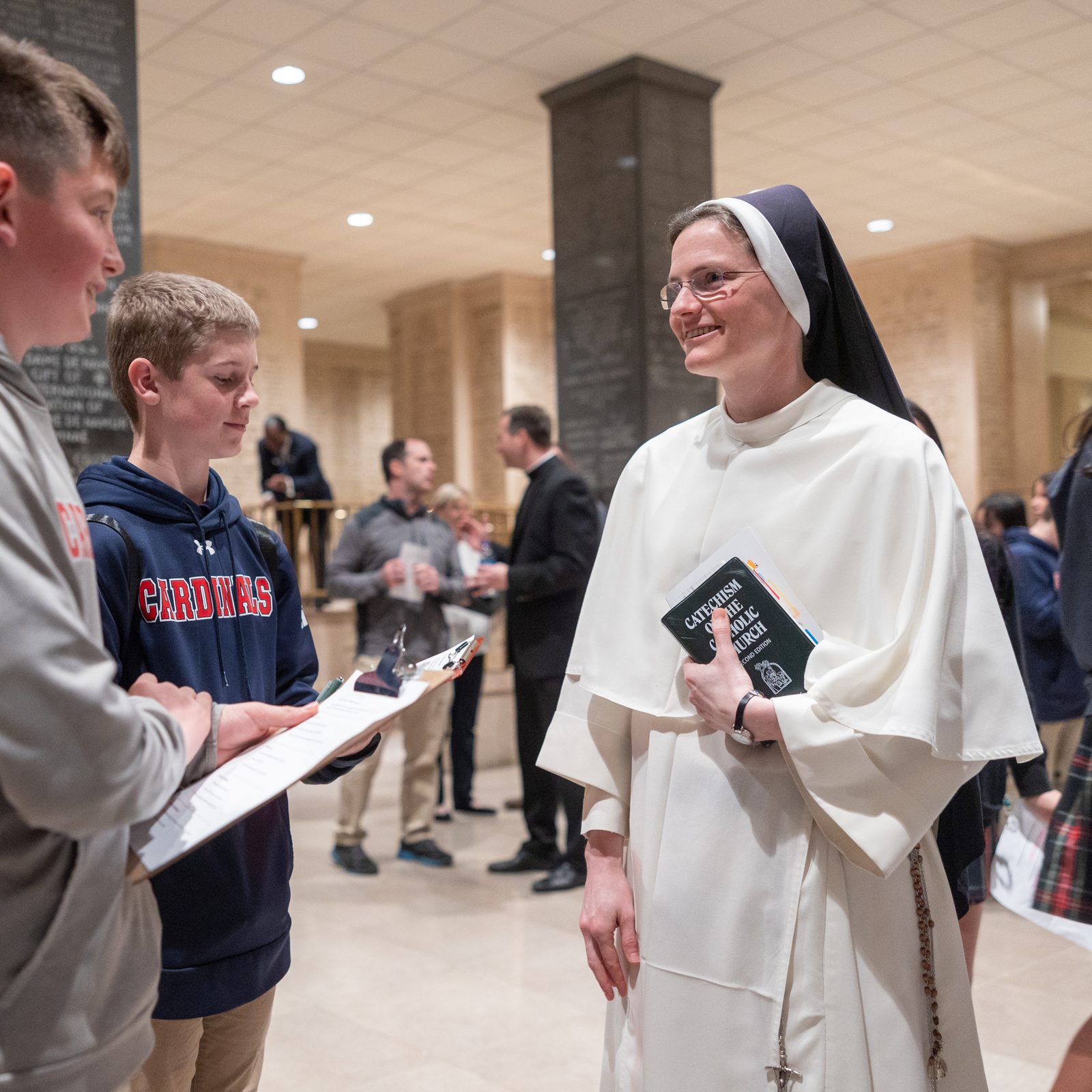 Sister Mary Josephine of the Dominican Sisters of Saint Cecilia speaks with students during the vocations fair held April 10 at the Basilica of the National Shrine of the Immaculate Conception in Washington, D.C., following the 29th annual Mass for Vocations. Sister Mary Josephine attended the Mass with some of her students from St. Anthony Catholic School in Washington, DC. (Catholic Standard photo by Mihoko Owada)