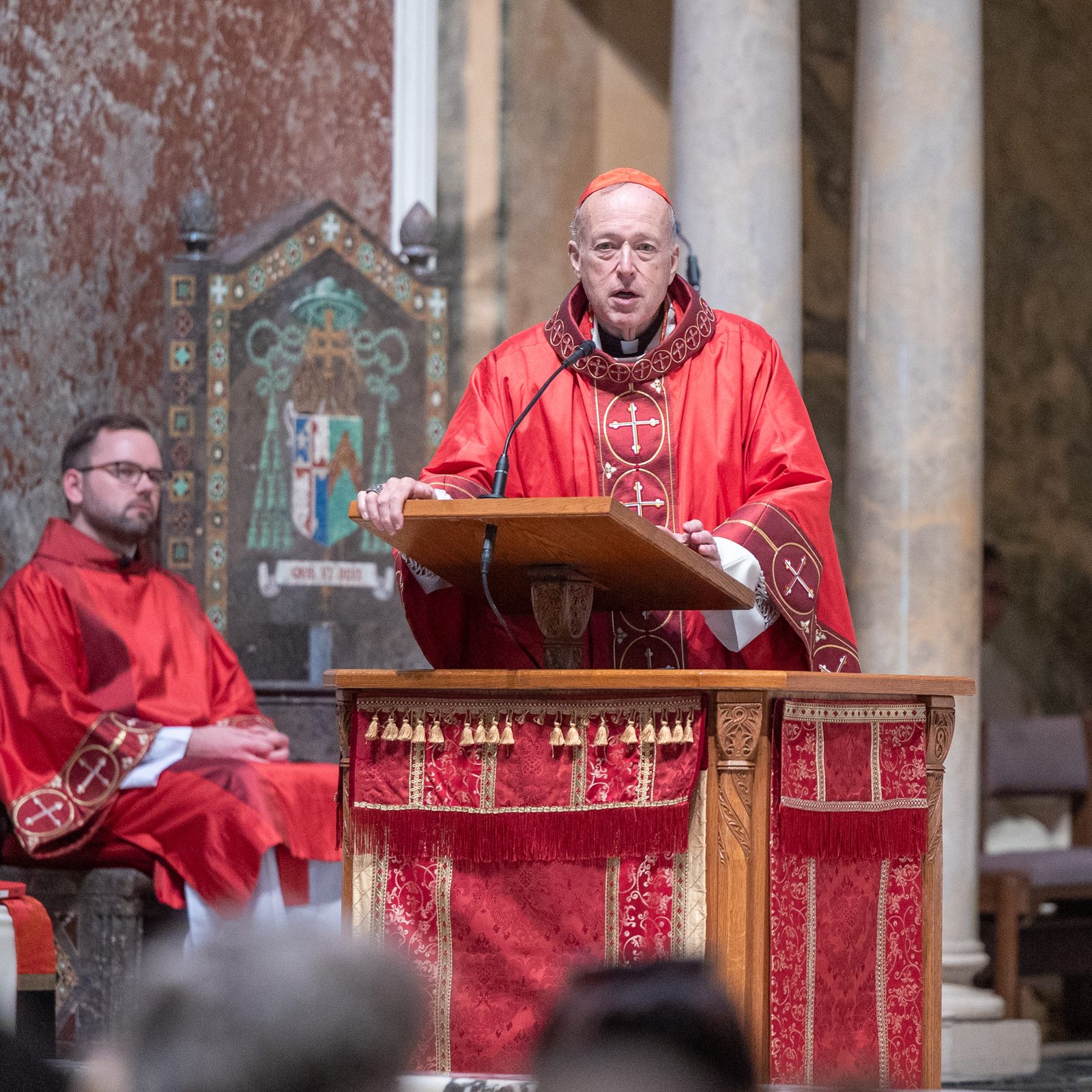 Cardinal Robert W. McElroy, the archbishop of Washington, gives the homily during a Liturgy of the Lord’s Passion held on Good Friday, April 18, 2025, at the Cathedral of St. Matthew the Apostle. Msgr. W. Ronald Jameson, the cathedral’s rector, is at left. (Catholic Standard photo by Mihoko Owada)