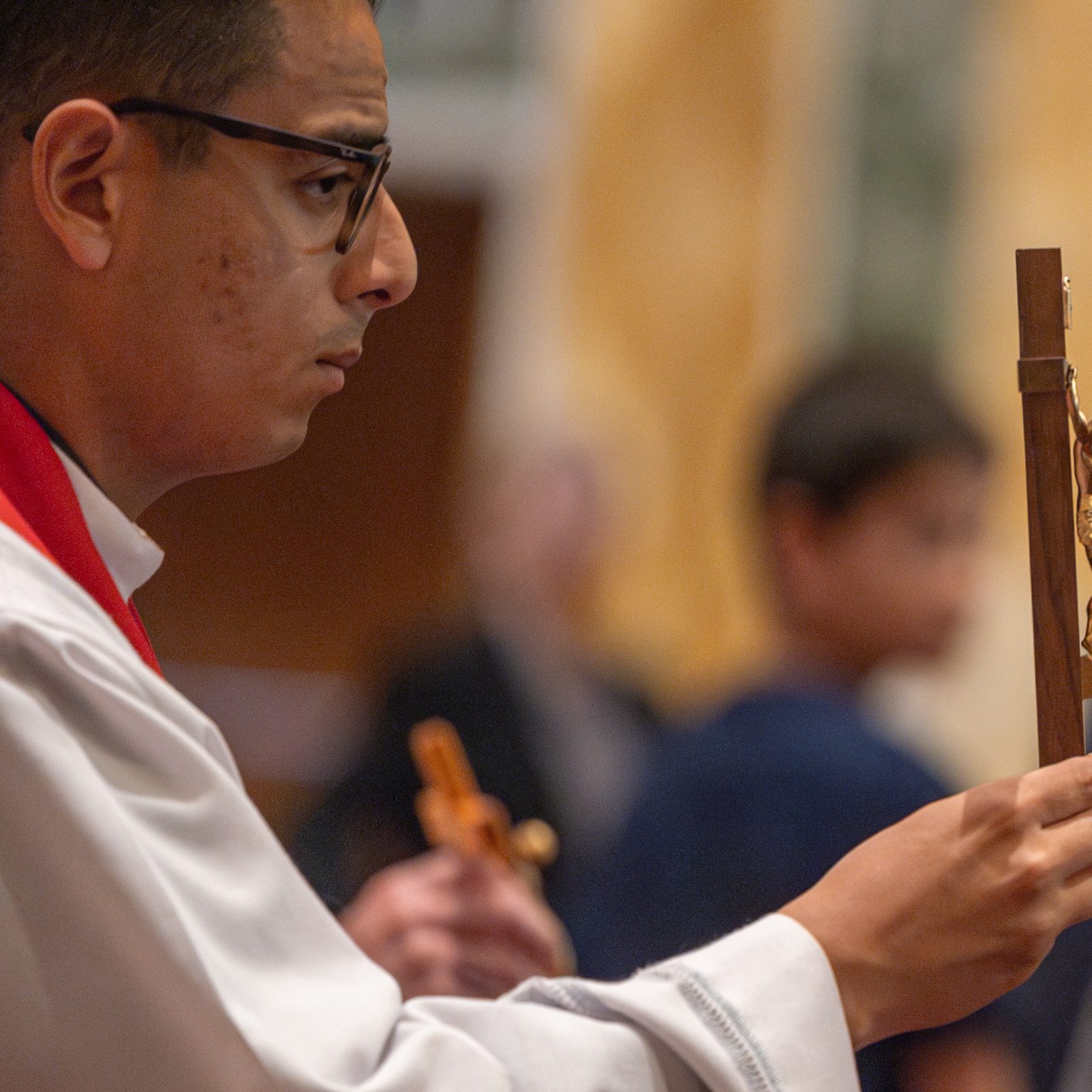 Father Isaac Sagastume, a parochial vicar at the Cathedral of St. Matthew the Apostle in Washington, holds a cross for people to venerate during a Liturgy of the Lord’s Passion held on Good Friday, April 18, 2025, at the cathedral. (Catholic Standard photos by Mihoko Owada)