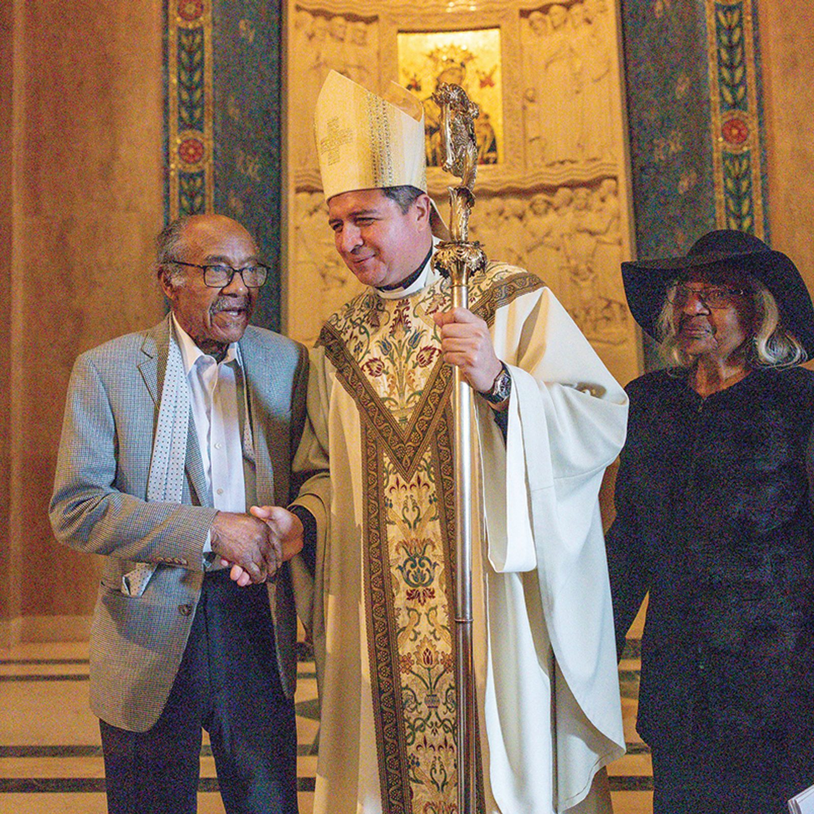 Eddie and Doris Sullivan – members of Our Lady Queen of Peace Parish in Washington, D.C., who have been married for 72 years – are congratulated by Auxiliary Bishop Evelio Menjivar after the annual Mass celebrating the Vocation of Marriage on Feb. 10, 2024 at the National Shrine. (Catholic Standard photo by Mihoko Owada)