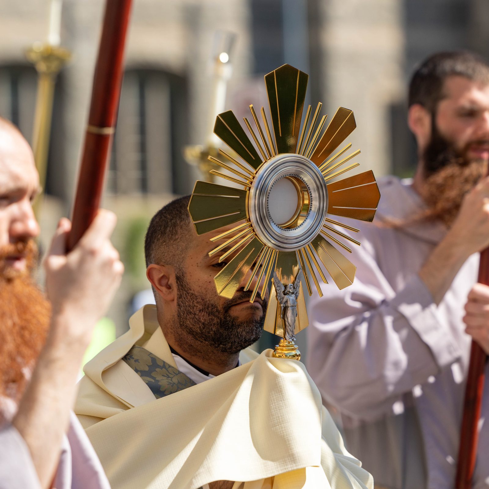 The monstrance containing the Eucharist is held aloft by Father Robert Boxie III, the Catholic chaplain at Howard University,as it is processed June 8 through the Brookland neighborhood of Washington, D.C. (CS photo by Mihoko Owada)