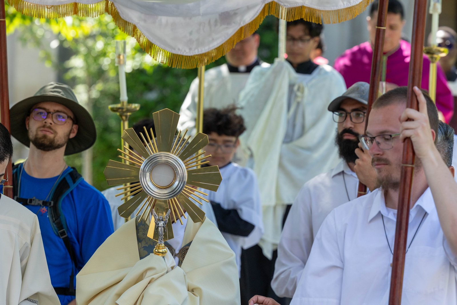 The monstrance containing the Eucharist is held aloft as it is processed June 8 through the Brookland neighborhood of Washington, D.C. (CS photo by Mihoko Owada)