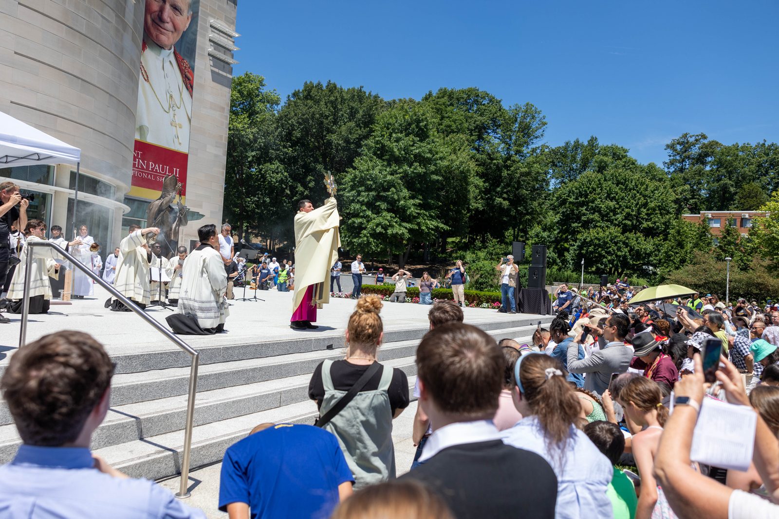Washington Auxiliary Bishop Evelio Menjivar presides at a Benediction outside the Saint John Paul II National Shrine at the conclusion of a Eucharistic procession on June 8.(Catholic Standard photo by Mihoko Owada)