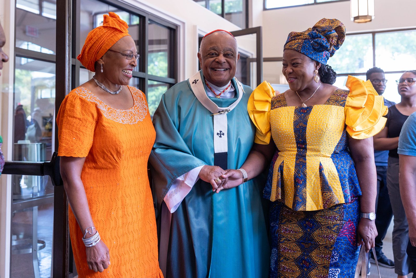 After a Mass on June 30, 2024 marking the 50th anniversary of Mother Seton Parish in Germantown, Maryland, Cardinal Wilton Gregory poses for a photo with women wearing traditional African dress. (Catholic Standard photo by Mihoko Owada)