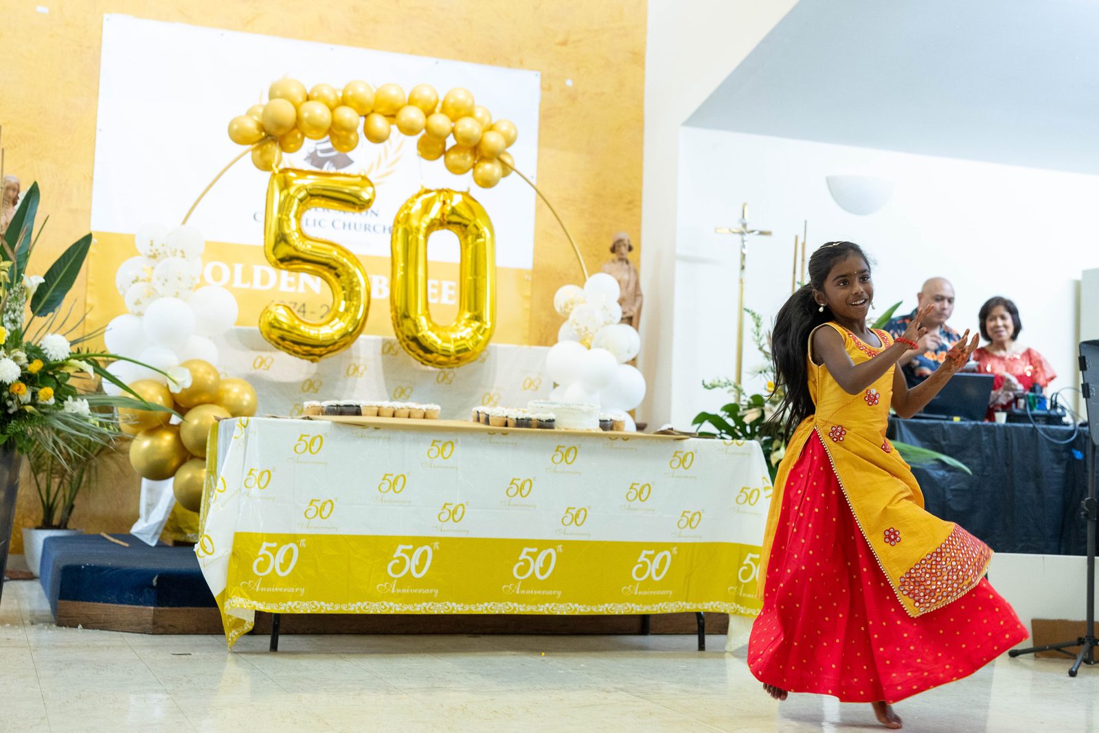At a June 30 reception celebrating the 50th anniversary of Mother Seton Parish in Germantown, Maryland, a girl performs a traditional Asian dance. (Catholic Standard photos by Mihoko Owada)