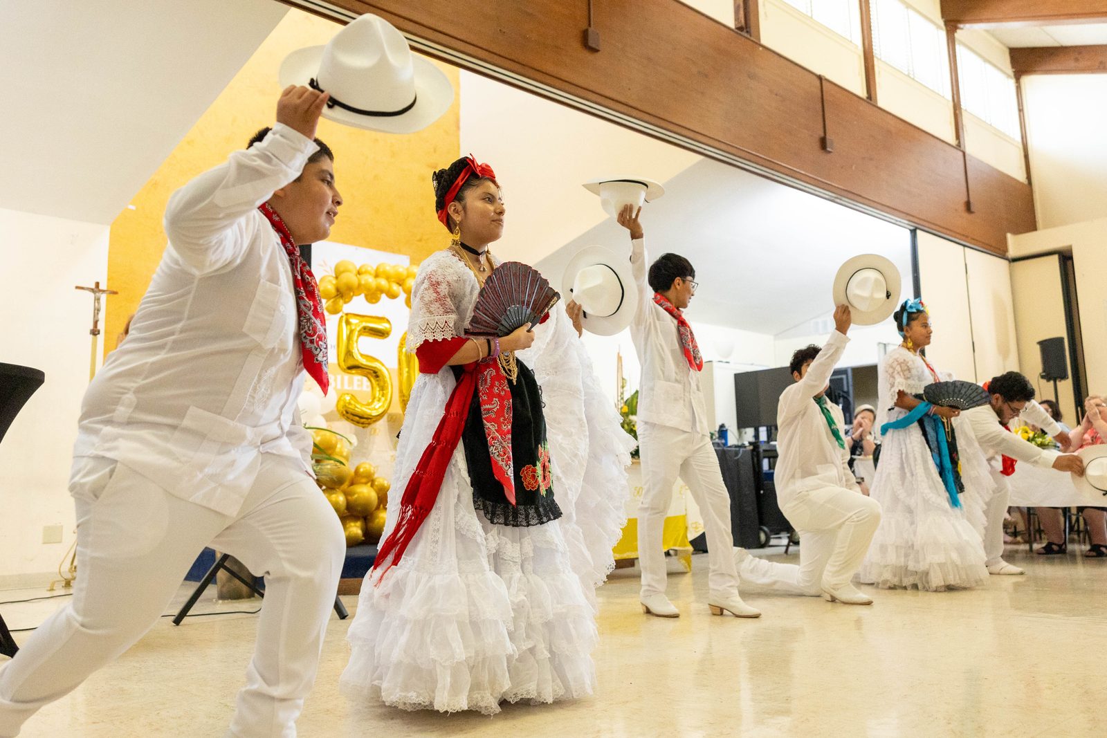 Youth at a June 30 reception celebrating the 50th anniversary of Mother Seton Parish in Germantown, Maryland, perform a traditional Mexican dance. (Catholic Standard photos by Mihoko Owada)
