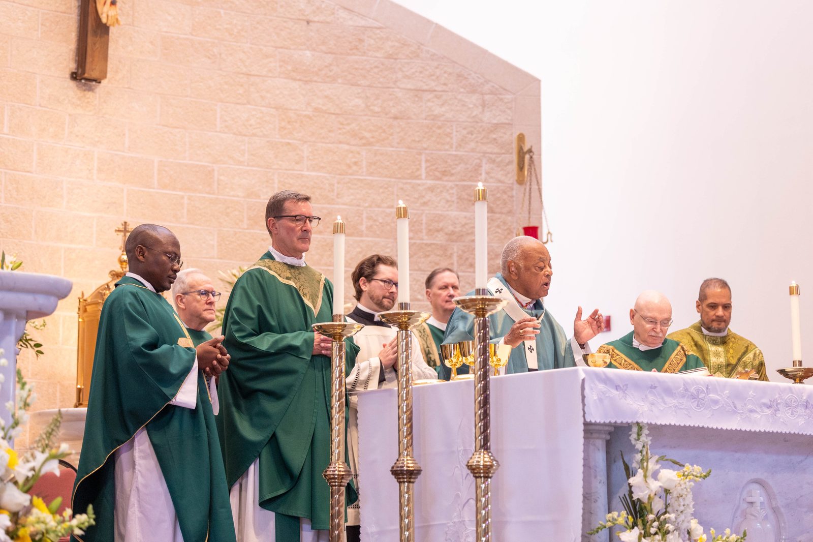 Washington Cardinal Wilton Gregory was the main celebrant of a Mass on June 30, 2024, marking the 50th anniversary of Mother Seton Parish in Germantown, Maryland. From left to right are Father Antonio Koffi, a member of the Missionaries of Africa who celebrates French-language Masses there for the parish’s African community; Deacon Francis Bendel; Father Lee Fangmeyer, Mother Seton’s pastor; Father Kevin Regan, the cardinal’s priest secretary; Deacon Stephen Maselko; Cardinal Gregory; Father Raymond Fecteau, a longtime area police chaplain who celebrates Masses there; and Father Rick Gancayco, a priest in residence at Mother Seton. Not pictured is Father Louis Faust, a retired priest who has served at the parish since 2008. (Catholic Standard photo by Mihoko Owada)