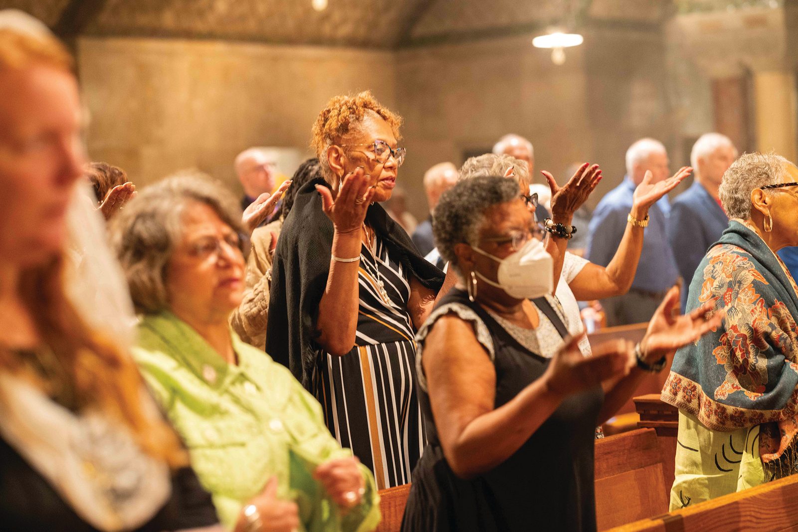Above and below, people pray during the June 29 Mass Thanksgiving in the Crypt Church of the Basilica of the National Shrine of the Immaculate Conception honoring the life and legacy of Father Clarence Rivers. (CS photos by Andrew Biraj)