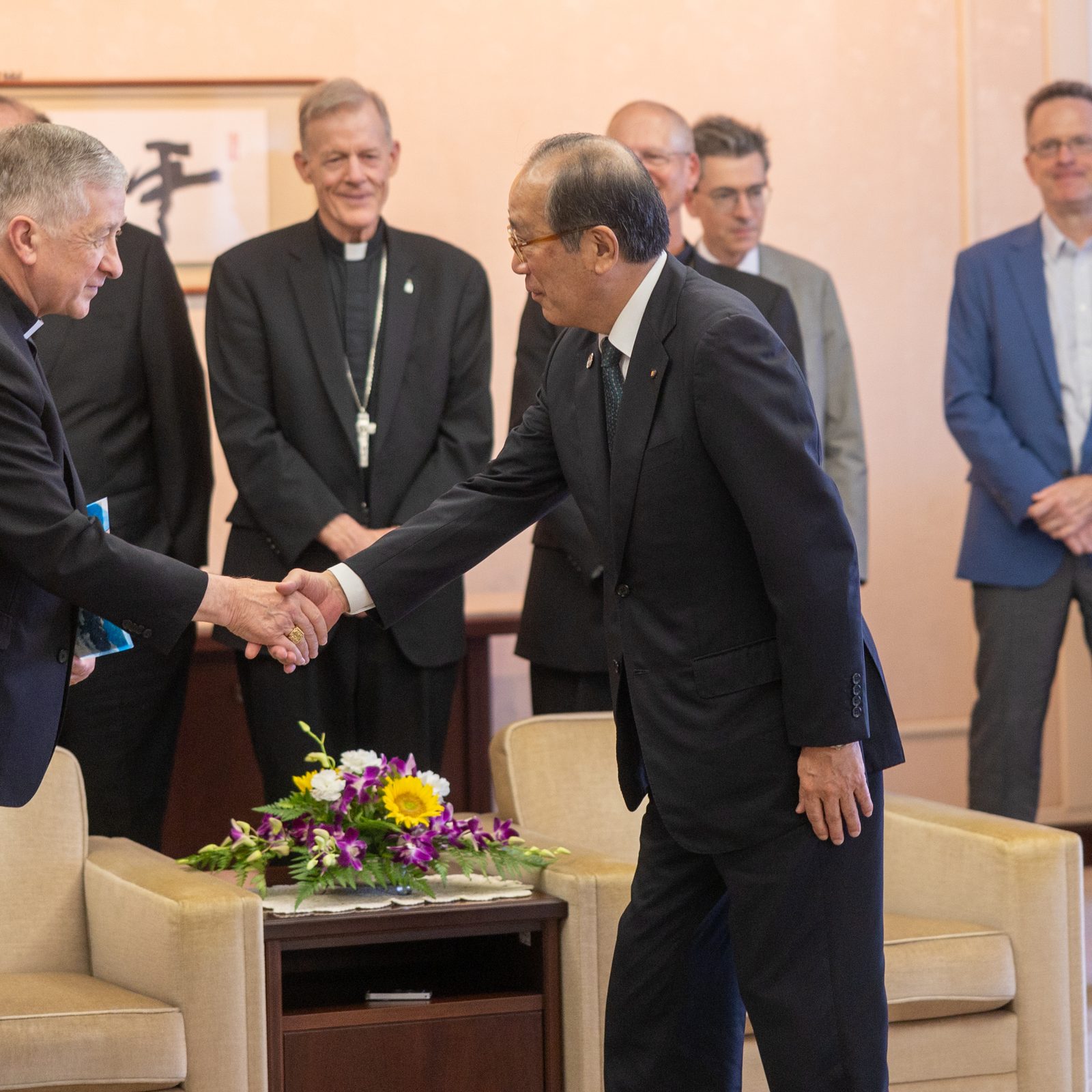 On Aug. 5, 2025, Cardinal Blase J. Cupich of Chicago shakes hands with Hiroshima Mayor Kazumi Matsui after a meeting with representatives from four archdioceses and Catholic universities in the United States. (Catholic Standard photo by Mihoko Owada)