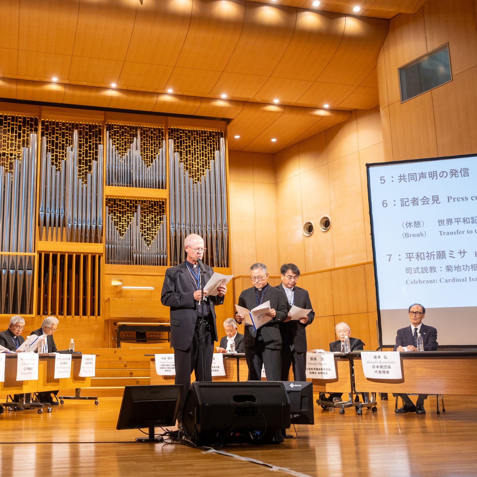 A joint statement, "Toward Solidarity to Protect All Life" is presented in three languages, English, Korean and Japanese by Archbishop Paul D. Etienne of Seattle; Bishop Simon Kim Ju-young of Chuncheon, South Korea; and Archbishop Peter Michiaki Nakamura of Nagasaki, Japan, at a peace event on Aug. 5, 2025 hosted by the Diocese of Hiroshima where atomic bombing survivors were honored. (Catholic Standard photo by Mihoko Owada)