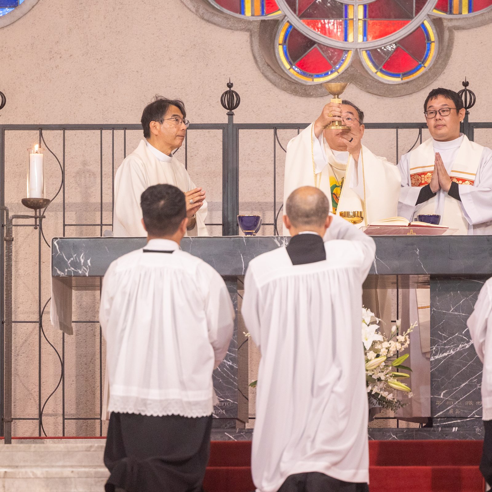 During the Peace Memorial Mass on Aug. 5, 2025 at the Memorial Cathedral for World Peace in Hiroshima, Japan, Cardinal Tarcisio Isao Kikuchi of Tokyo elevates the chalice. The concelebrants at the Mass included Archbishop Peter Michiaki Nakamura of Nagasaki (at left) and Cardinal Thomas Aquino Manyo Maeda of Osaka-Takamatsu, Japan (right). (Catholic Standard photo by Mihoko Owada)