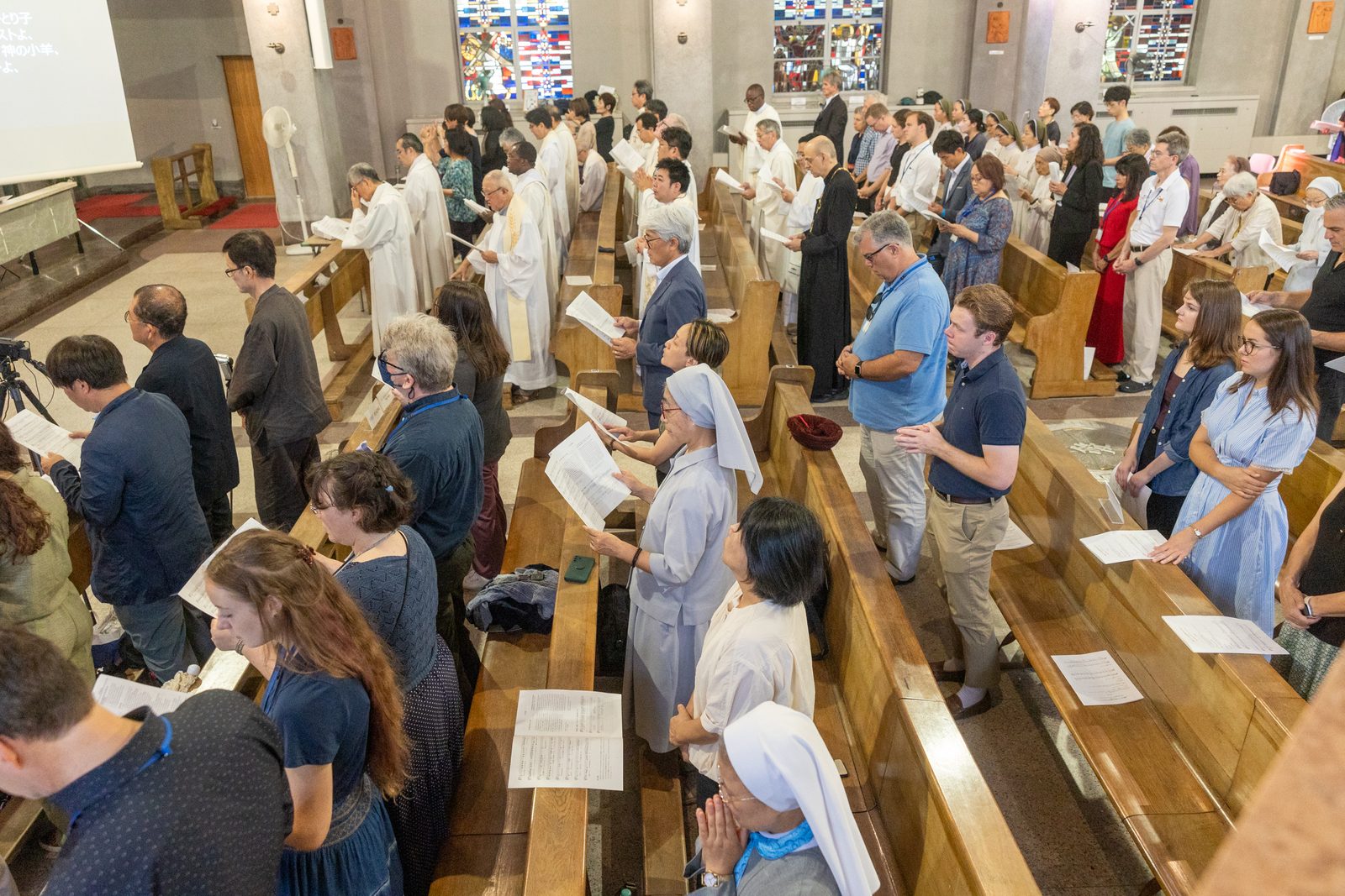 People pray during a Mass on Aug. 6, 2025 at the World Peace Memorial Cathedral in Hiroshima, Japan, for the Victims of the Atomic Bombing. (Catholic Standard photo by Mihoko Owada)