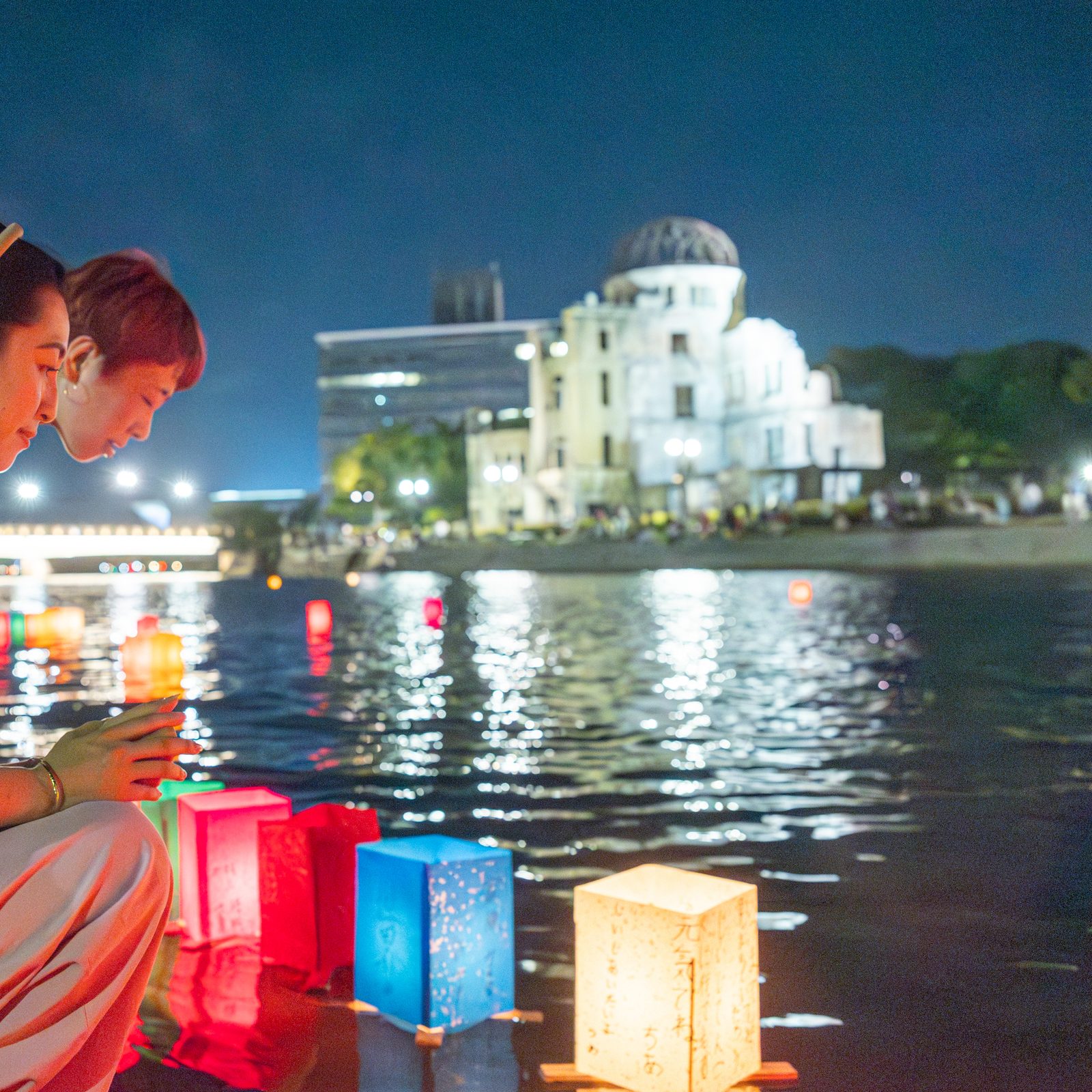 People release paper lanterns on the Motoyasu River facing the gutted Atomic Bomb Dome in Hiroshima, Japan, on Aug. 6, 2025, the 80th anniversary of the United States dropping the atomic bomb on Hiroshima. (Catholic Standard photo by Mihoko Owada)