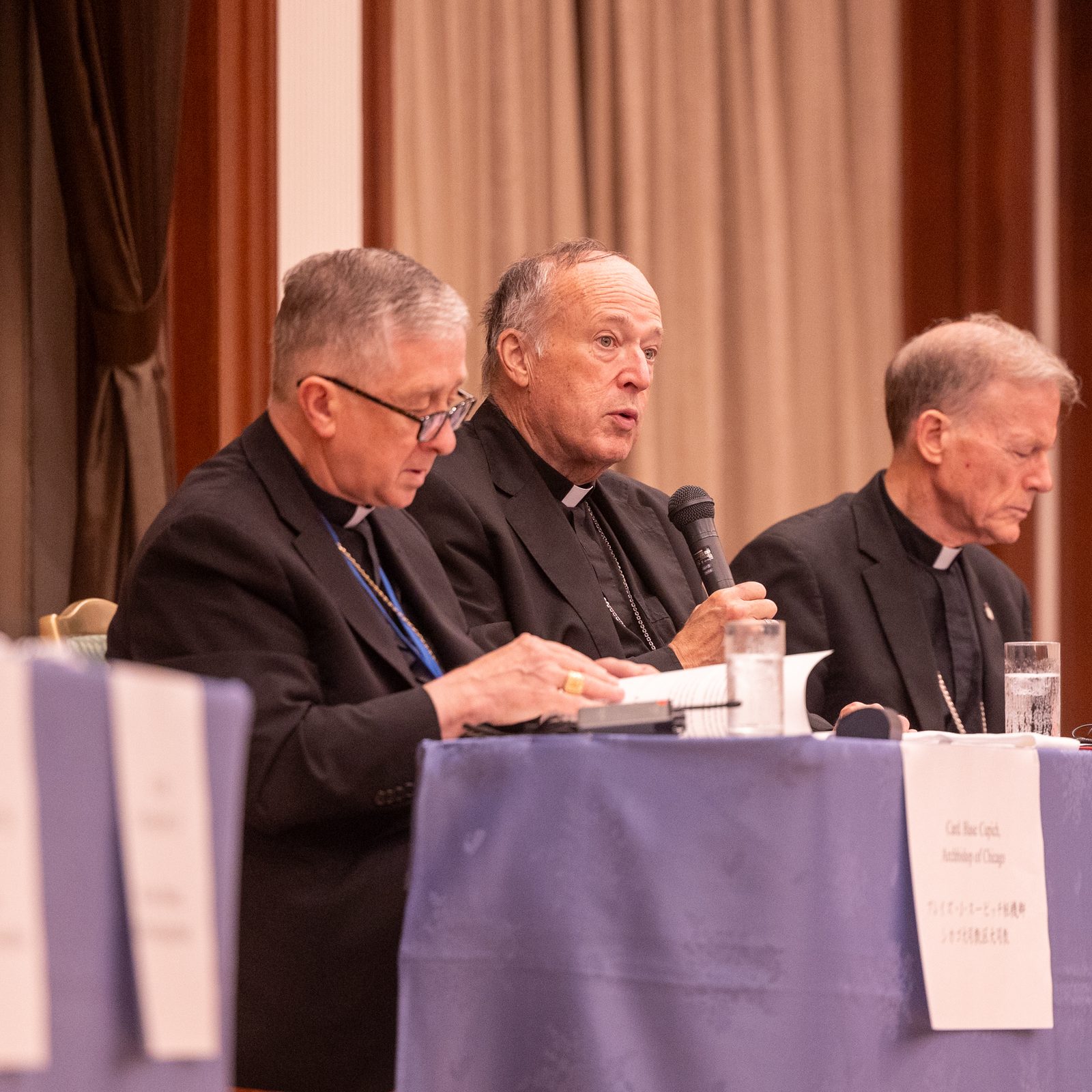 The U.S. archbishops participating in a symposium on nuclear weapons issues and world peace hosted by the Nagasaki Interreligious Fellowship for Peace on Aug. 7, 2025 as part of events commemorating the 80th anniversary of the U.S. atomic bombings of Hiroshima and Nagasaki included from left to right, Chicago Cardinal Blase J. Cupich, Washington Cardinal Robert W. McElroy and Archbishop John C. Wester of Santa Fe, New Mexico. Those archbishops, along with Seattle Archbishop Paul D. Etienne and Catholic university leaders and students, participated in a Pilgrimage of Peace to Japan that week. (Catholic Standard photo by Mihoko Owada)