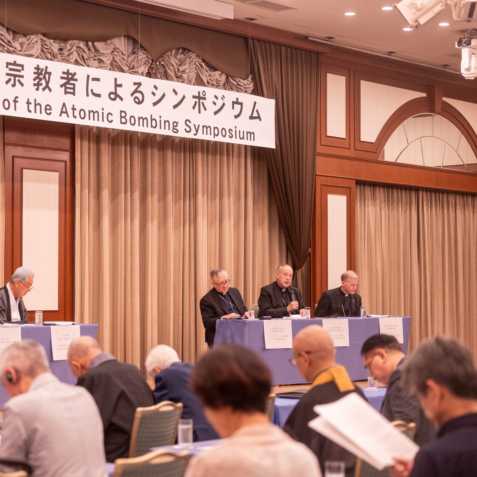 The U.S. archbishops participating in a symposium on nuclear weapons issues and world peace hosted by the Nagasaki Interreligious Fellowship for Peace on Aug. 7, 2025 as part of events commemorating the 80th anniversary of the U.S. atomic bombings of Hiroshima and Nagasaki included from left to right, Chicago Cardinal Blase J. Cupich, Washington Cardinal Robert W. McElroy and Archbishop John C. Wester of Santa Fe, New Mexico. Those archbishops, along with Seattle Archbishop Paul D. Etienne and Catholic university leaders and students, participated in a Pilgrimage of Peace to Japan that week. (Catholic Standard photo by Mihoko Owada)