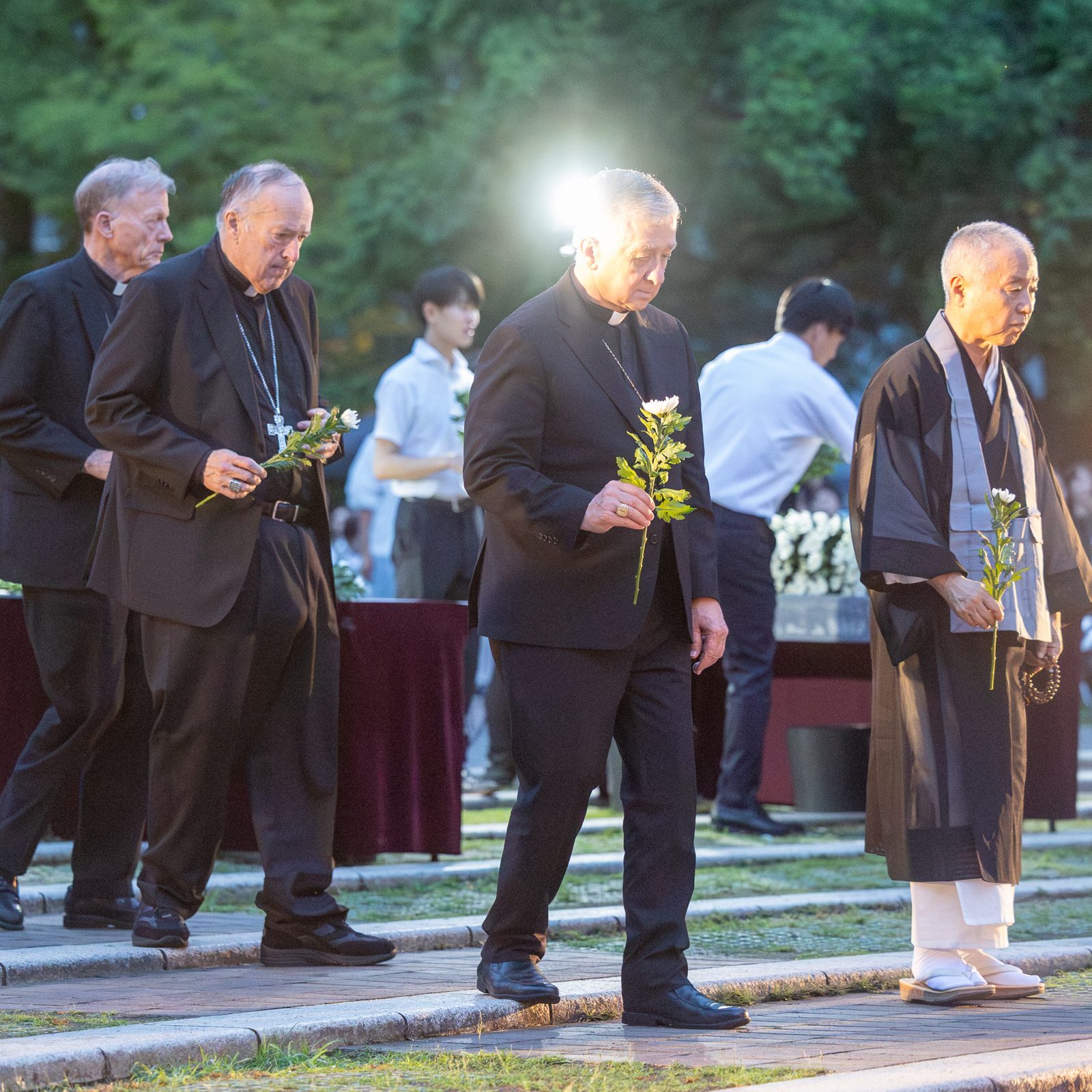 At the Memorial Service for the Victims of the Atomic Bombing held in Nagasaki Hypocenter Park on Aug. 8, 2025, participants in a Pilgrimage of Peace from the United States offer flowers. From left to right are Professor James L. Nolan Jr., a professor of sociology at Williams College in Williamstown, Massachusetts; Holy Cross Father Robert A. Dowd, the president of the University of Notre Dame; Archbishop John C. Wester of Santa Fe, New Mexico; Washington Cardinal Robert W. McElroy; and Chicago Cardinal Blase J. Cupich. (Catholic Standard photo by Mihoko Owada)