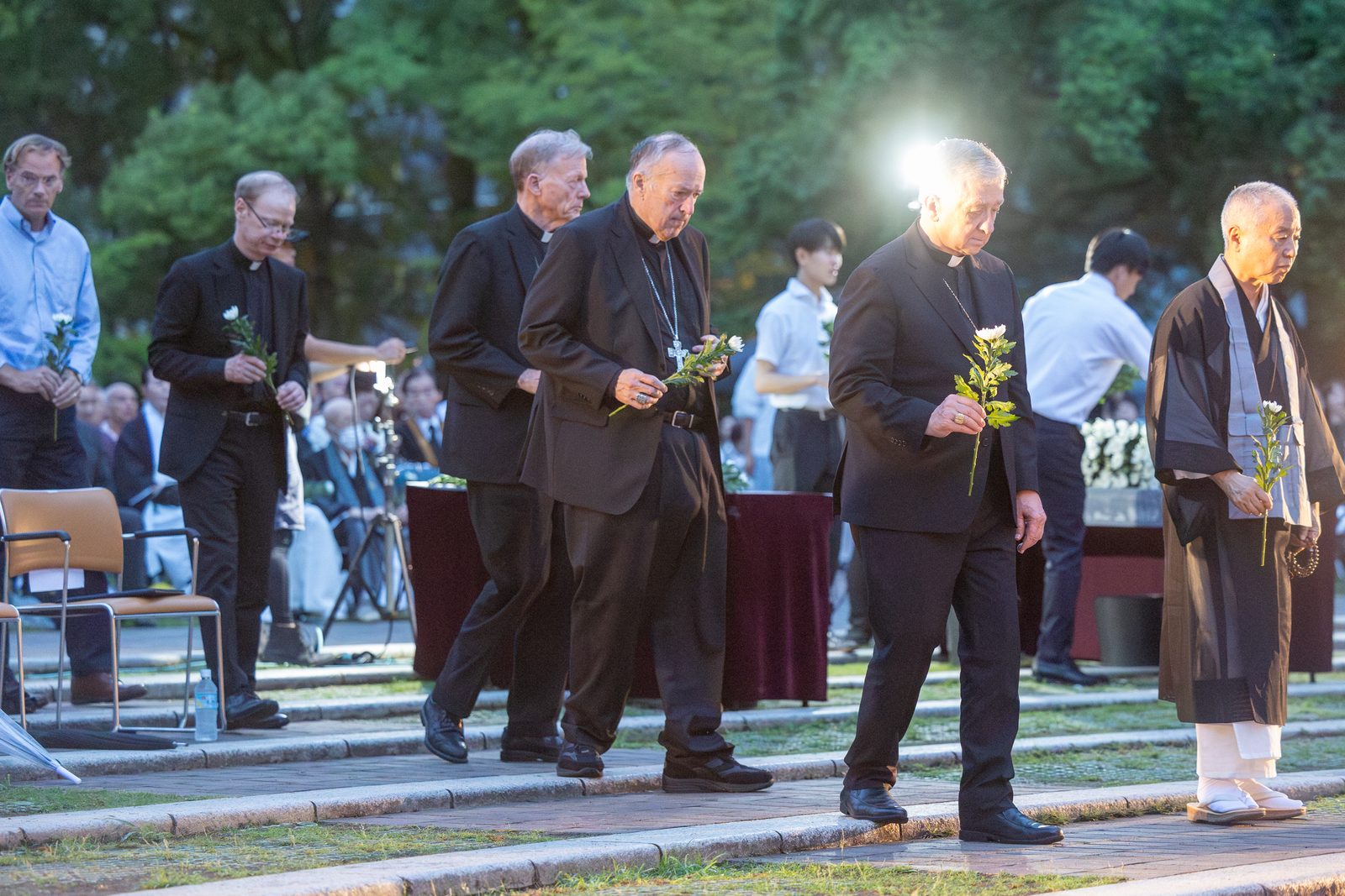 At the Memorial Service for the Victims of the Atomic Bombing held in Nagasaki Hypocenter Park on Aug. 8, 2025, participants in a Pilgrimage of Peace from the United States offer flowers. From left to right are Professor James L. Nolan Jr., a professor of sociology at Williams College in Williamstown, Massachusetts; Holy Cross Father Robert A. Dowd, the president of the University of Notre Dame; Archbishop John C. Wester of Santa Fe, New Mexico; Washington Cardinal Robert W. McElroy; and Chicago Cardinal Blase J. Cupich. (Catholic Standard photo by Mihoko Owada)