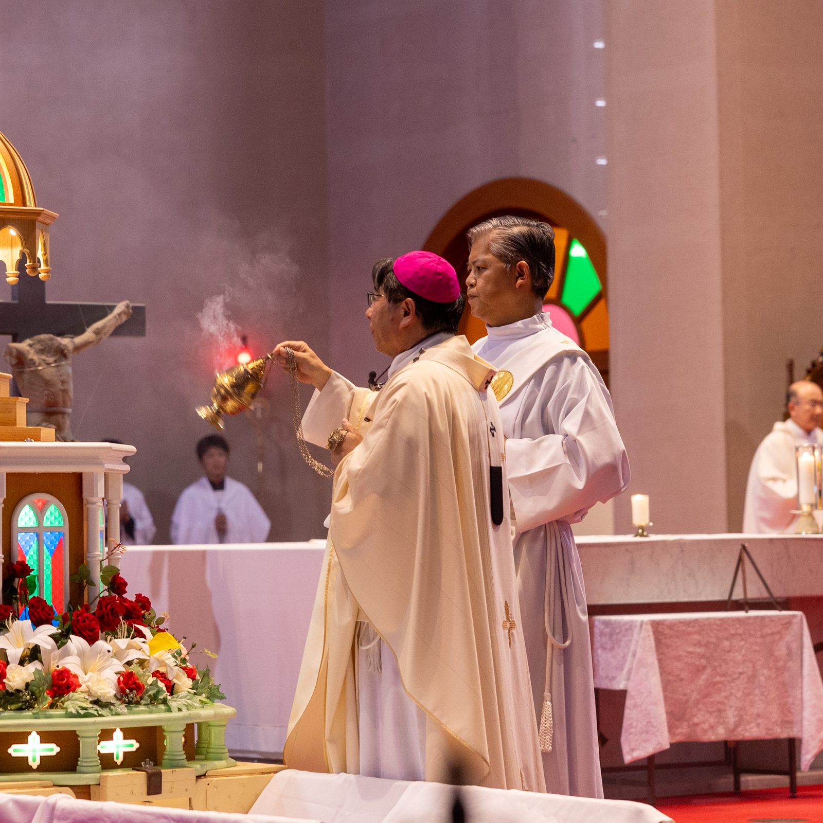 At the beginning of a Peace Memorial Mass at Urakami Cathedral in Nagasaki, Japan, on Aug. 9, 2025, on the day of the 80th anniversary of the U.S. atomic bombing of that city, Archbishop Peter Michiaki Nakamura of Nagasaki incenses the head of a statue of Mary that was recovered in the rubble of the original cathedral that was destroyed in the bombing there. In the background is a crucifix also recovered there in the aftermath of the bombing 80 years ago, with the head, arm and parts of the legs of the figure of Jesus missing. (Catholic Standard photo by Mihoko Owada)