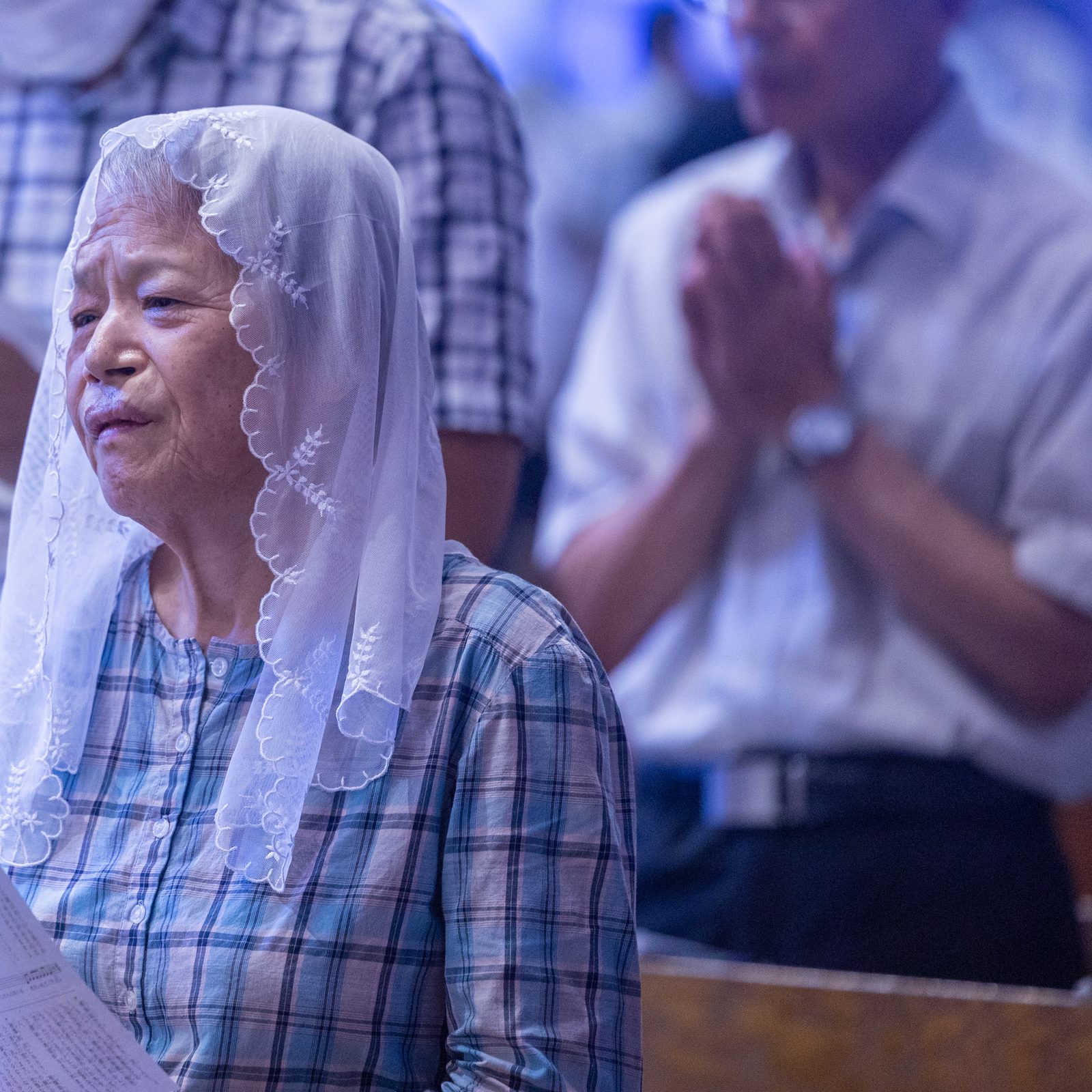 A woman prays during the 11 a.m. Mass at Urakami Cathedral in Nagasaki, Japan on Aug. 9, 2025 when the two bells rang out together at 11:02 a.m. for the first time in 80 years. One of these bells was recast for the cathedral by American Catholics. The bells rang out on the 80th anniversary of the moment when the atomic bomb dropped by the United States exploded over Nagasaki on Aug. 9, 1945. (Catholic Standard photo by Mihoko Owada)