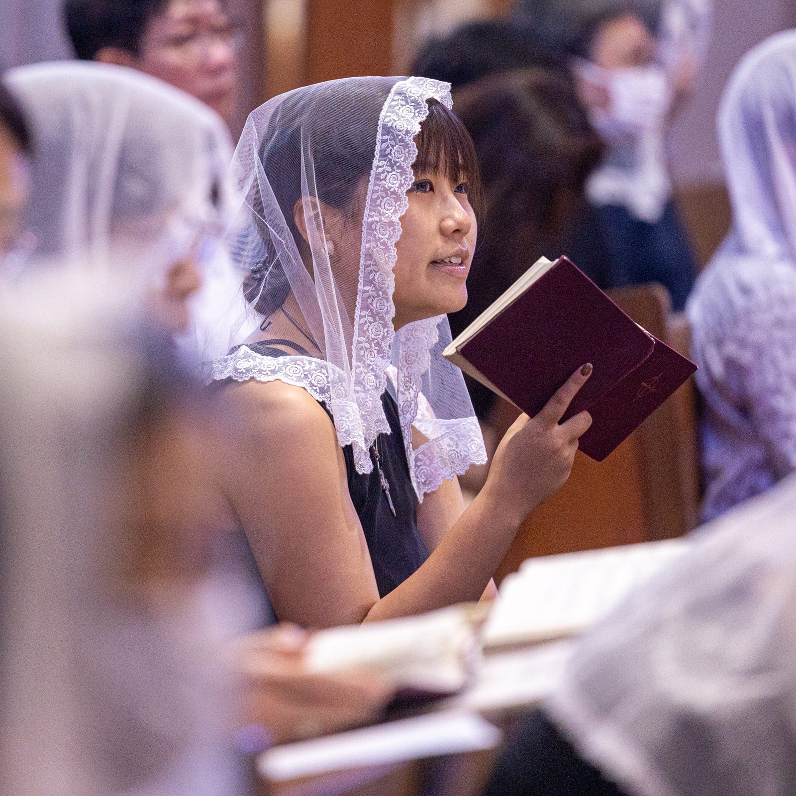 A woman sings during the 11 a.m. Mass at Urakami Cathedral in Nagasaki, Japan on Aug. 9, 2025 when the two bells rang out together at 11:02 a.m. for the first time in 80 years. One of these bells was recast for the cathedral by American Catholics. The bells rang out on the 80th anniversary of the moment when the atomic bomb dropped by the United States exploded over Nagasaki on Aug. 9, 1945. (Catholic Standard photo by Mihoko Owada)