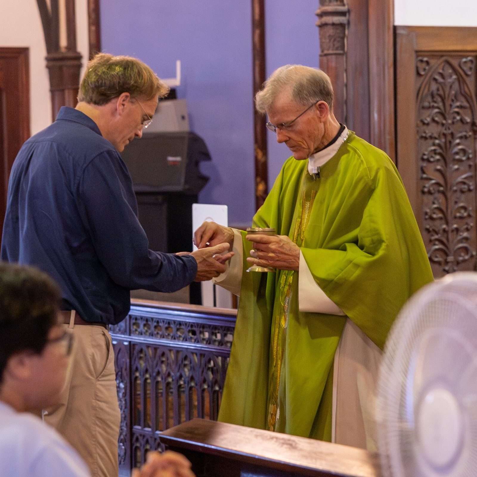 James L. Nolan Jr., a professor of sociology at Williams College in Williamstown, Massachusetts, receives Communion from Archbishop John C. Wester of Santa Fe, New Mexico, during a Mass on Aug. 10, 2025 at Oura Cathedral in Nagasaki. The historic church is where “hidden Catholics” who had kept the faith for generations in Japan were rediscovered in 1865. The people attending the Mass included participants in a Pilgrimage of Peace from the United States, who were in Japan to dialogue and pray for peace and for an end to nuclear weapons on the 80th anniversary of the U.S. dropping atomic bombs on Hiroshima and Nagasaki on Aug. 6 and 9, 1945. (Catholic Standard photo by Mihoko Owada)