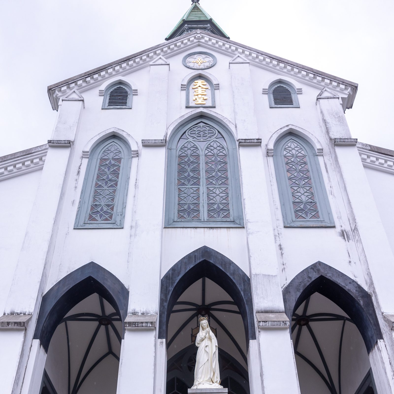 On the morning of August 10, 2025, Archbishop Paul D. Etienne of Seattle and Archbishop John C. Wester of Santa Fe, New Mexico stand in front of Oura Cathedral in Nagasaki after celebrating Mass. Oura Cathedral is dedicated to the 26 martyrs of Japan, and was also the stage for an event which became known as the “Discovery of Christians” of Japan. At the time when it was constructed, foreigners residing in Japan were allowed to be Christian, but for Japanese people it was still forbidden. The “discovery of Christians in Japan” refers to the moment in 1865 when, after over 250 years of secrecy and persecution, Japanese Christians revealed their continued faith to foreign missionaries, most notably Father Bernard Petitjean, at the Oura Church in Nagasaki. (Catholic Standard photo by Mihoko Owada)