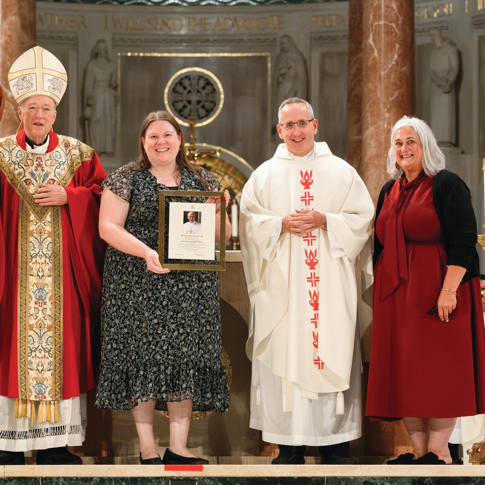 St. John the Evangelist Catholic Elementary School in Clinton, Maryland, was honored for its 65thanniversary during the Opening of Schools Mass for the Roman Catholic Archdiocese of Washington on Aug. 24 at the Basilica of the National Shrine of the Immaculate Conception. From left to right are Washington Cardinal Robert W. McElroy; Sarah Bento, the principal of St. John the Evangelist School; Father Dan Leary, the pastor of St. John the Evangelist Parish; and Kelly Branaman, the Secretary for Catholic Schools and Superintendent of Schools for the Archdiocese of Washington. (Catholic Standard photo by Nicole Olea)