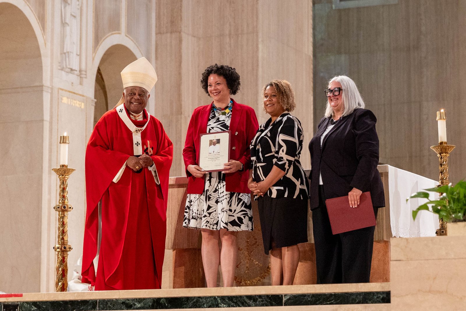 At the Opening of Schools Mass on Aug. 26 at the National Shrine, the local Catholic schools celebrating milestone anniversaries this year included Elizabeth Seton High School in Bladensburg, Maryland, which is marking its 65th anniversary. From left to right are Cardinal Wilton Gregory; Dr. Lisa Grillo, the president of Elizabeth Seton High School; Erica Boursiquot, the director of advancement at Elizabeth Seton; and Kelly Branaman, the Secretary for Catholic Schools and Superintendent of Schools for The Roman Catholic Archdiocese of Washington. (Catholic Standard photo by Mihoko Owada)