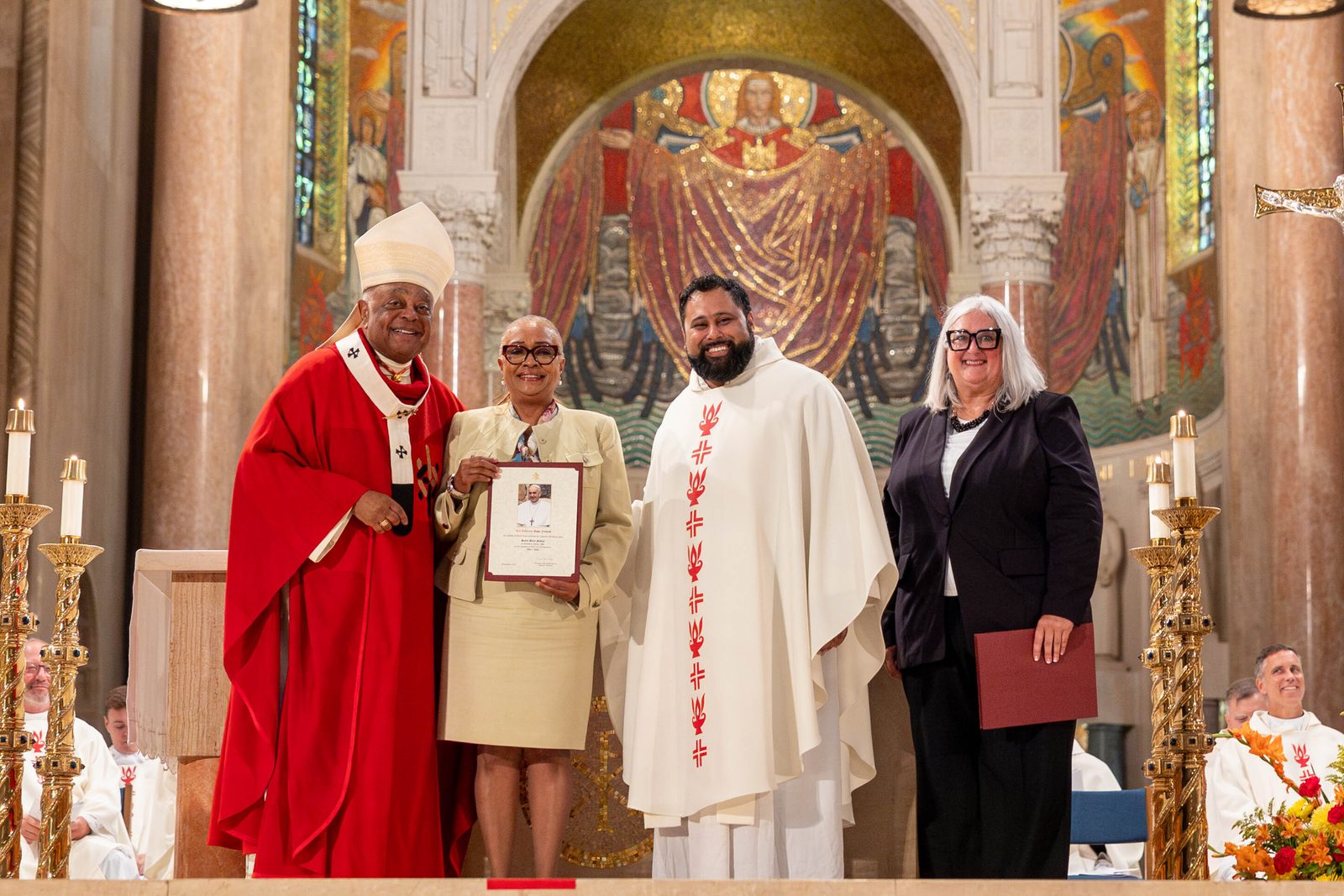 At the Opening of Schools Mass on Aug. 26 at the National Shrine, the local Catholic schools celebrating milestone anniversaries this year included St. Mary’s School in Landover Hills, Maryland, which is marking its 70th anniversary. From left to right are Cardinal Wilton Gregory; LaSandra Hayes, St. Mary’s principal; Father Mario Majano, St. Mary’s pastor; and Kelly Branaman, the Secretary for Catholic Schools and Superintendent of Schools for The Roman Catholic Archdiocese of Washington. (Catholic Standard photo by Mihoko Owada)