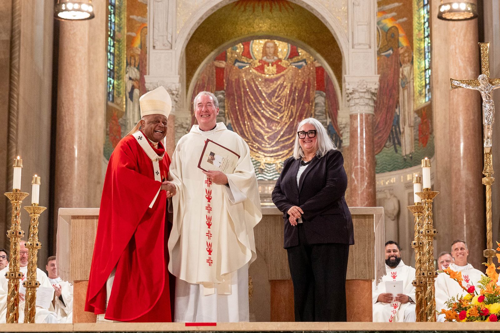 At the Opening of Schools Mass on Aug. 26 at the National Shrine, the local Catholic schools celebrating milestone anniversaries this year included Georgetown Preparatory School in North Bethesda, Maryland, which is marking its 235th anniversary. From left to right are Cardinal Wilton Gregory; Jesuit Father James Van Dyke, the president of Georgetown Preparatory School; and Kelly Branaman, the Secretary for Catholic Schools and Superintendent of Schools for The Roman Catholic Archdiocese of Washington. (Catholic Standard photo by Mihoko Owada)