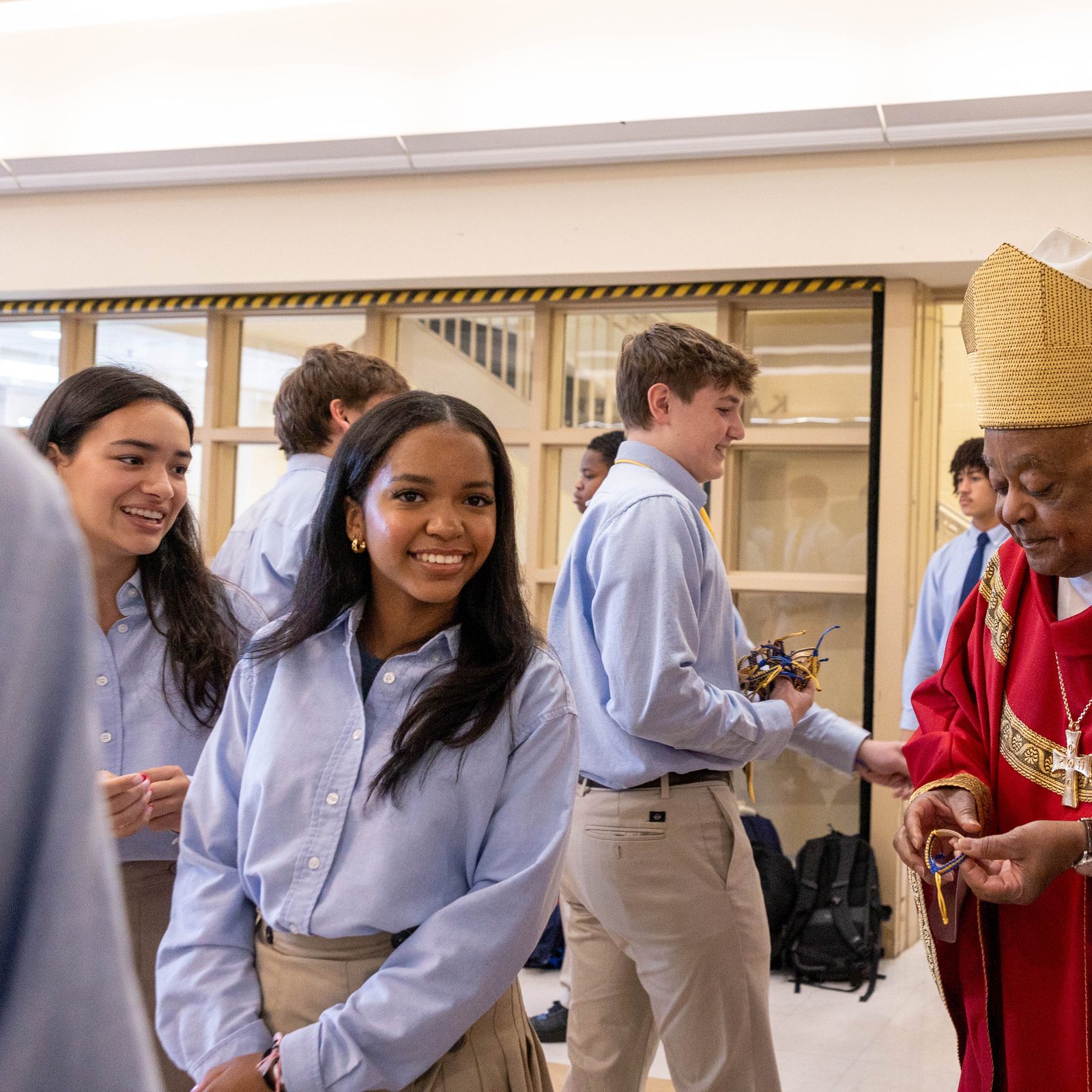 Washington Cardinal Wilton Gregory receives the trust bracelet given to him by students of Our Lady of Good Counsel High School in Olney before the opening school year Mass on August 29, 2024. The word “trust” was etched on the handcrafted bracelets, reflecting the Xaverian value being emphasized at the school this year. Standing at right is John Ciccone, the president of Our Lady of Good Counsel High School. (Catholic Standard photo by Mihoko Owada)