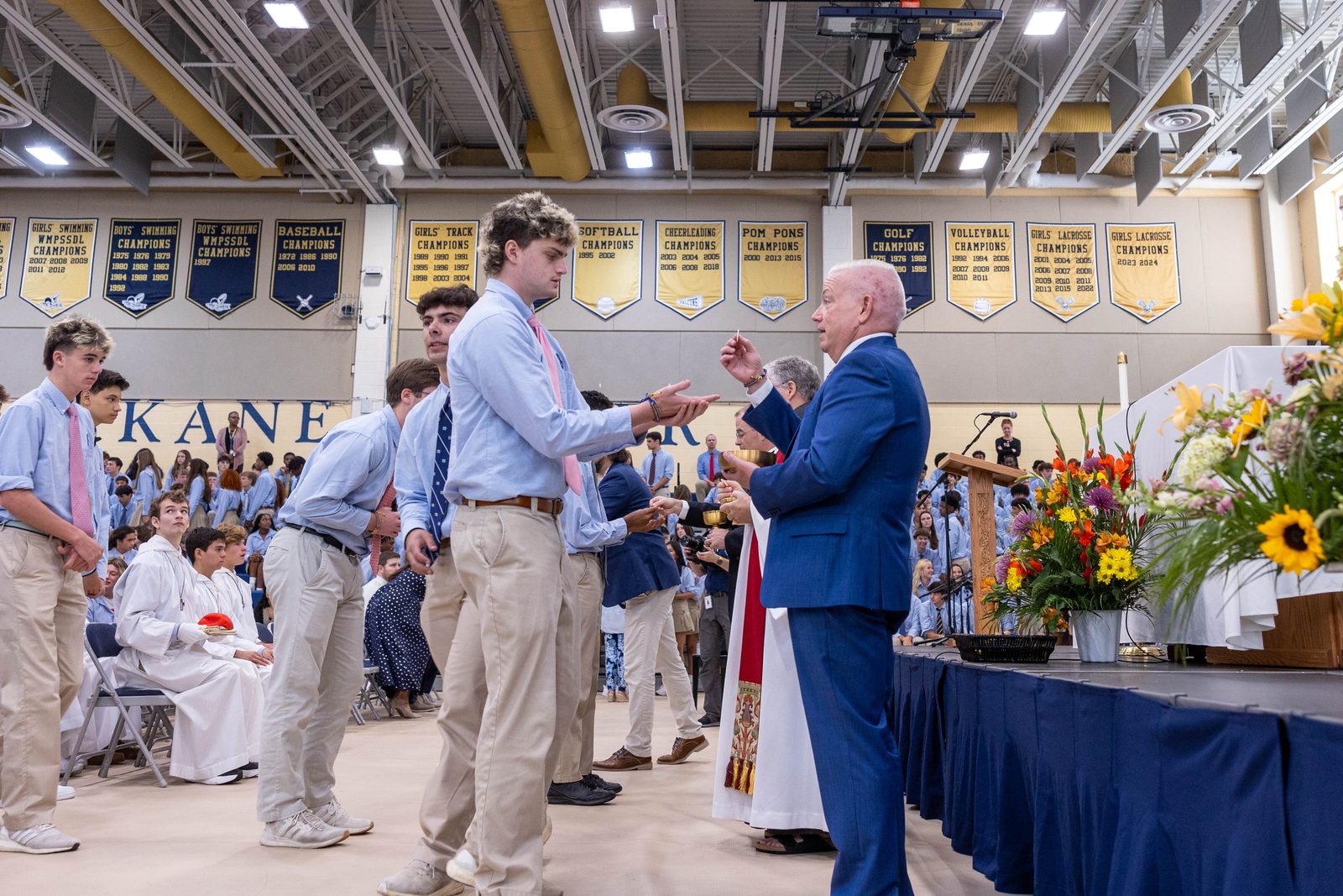 John Ciccone, the president of Our Lady of Good Counsel High School in Olney, Maryland, gives Communion to a student during the opening school year Mass there celebrated by Cardinal Wilton Gregory on Aug. 29. (Catholic Standard photo by Mihoko Owada)