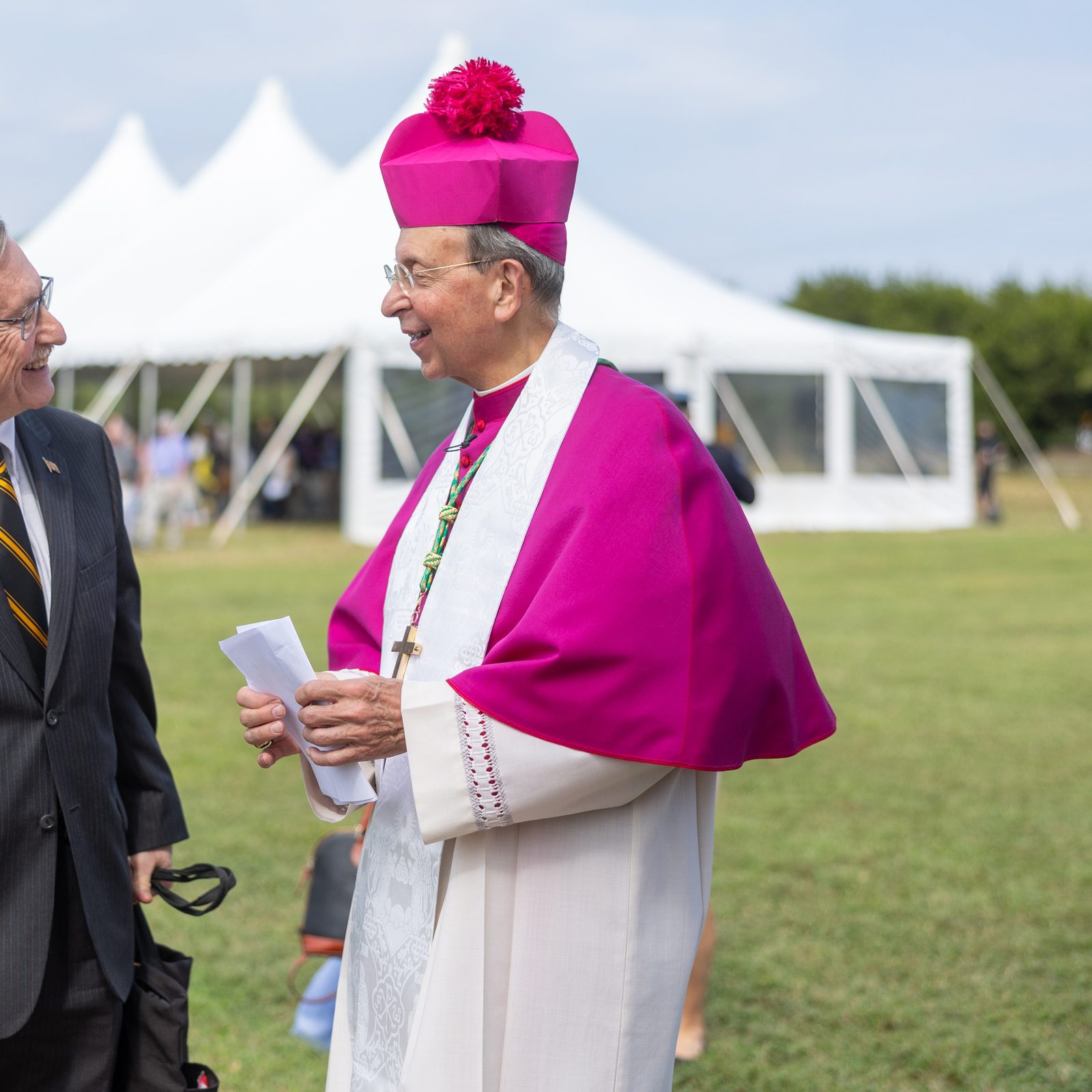 Historical archaeologist Dr. Henry Miller visits with Baltimore Archbishop William E. Lori after the reinterment ceremony for the remains of eight young children from colonial-era Maryland that were brought back to the site of the rebuilt 1667 Brick Chapel in Historic St. Mary’s City on Sept. 20, 2025. Archbishop Lori presided at the reinterment rite. Miller, a Maryland Heritage Scholar and the Senior Research Fellow at Historic St. Mary’s City, spoke at the ceremony, describing how the remains of 65 colonial-era Marylanders buried near the foundation of the original brick chapel were carefully removed so the reconstructed chapel could be built at the site. The reinterment rite marked the return of the remains of those early Marylanders to the site where they had been buried. (Catholic Standard photo by Mihoko Owada)