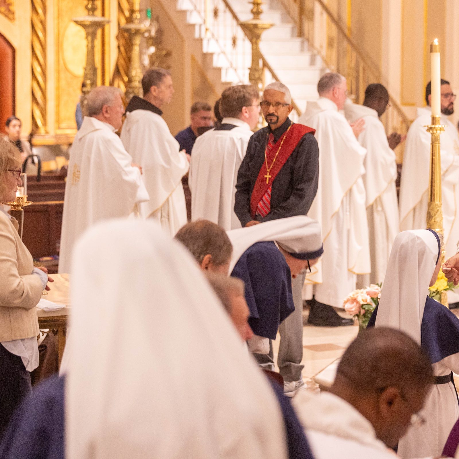 Franciscan Father Francesco Patton, the Custos of the Holy Land and guardian of the Holy Shrines of Christianity, distributes Holy Communion during the anniversary Mass at the Franciscan Monastery.(Catholic Standard photos by Mihoko Owada)