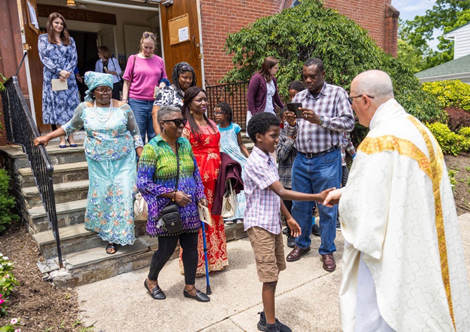 Father Thomas LaHood, the pastor of St. Mary of the Assumption Parish in Upper Marlboro, greets people after a Mass marking the parish’s 200th anniversary on June 2, 2024. (Catholic Standard photo by Andrew Biraj)