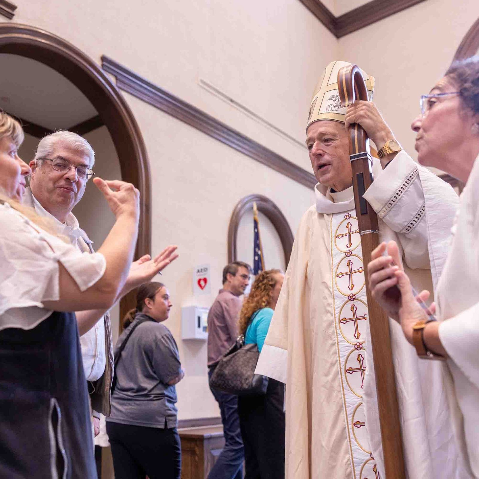 After the White Mass at Our Lady of Mercy Church in Potomac on Oct. 26, Jody Ferrell greets Cardinal McElroy in American Sign Language. At right is Mary O'Meara, executive director of the archdiocesan Office of Deaf and Disability Ministries. (Catholic Standard Photo by Mihoko Owada)