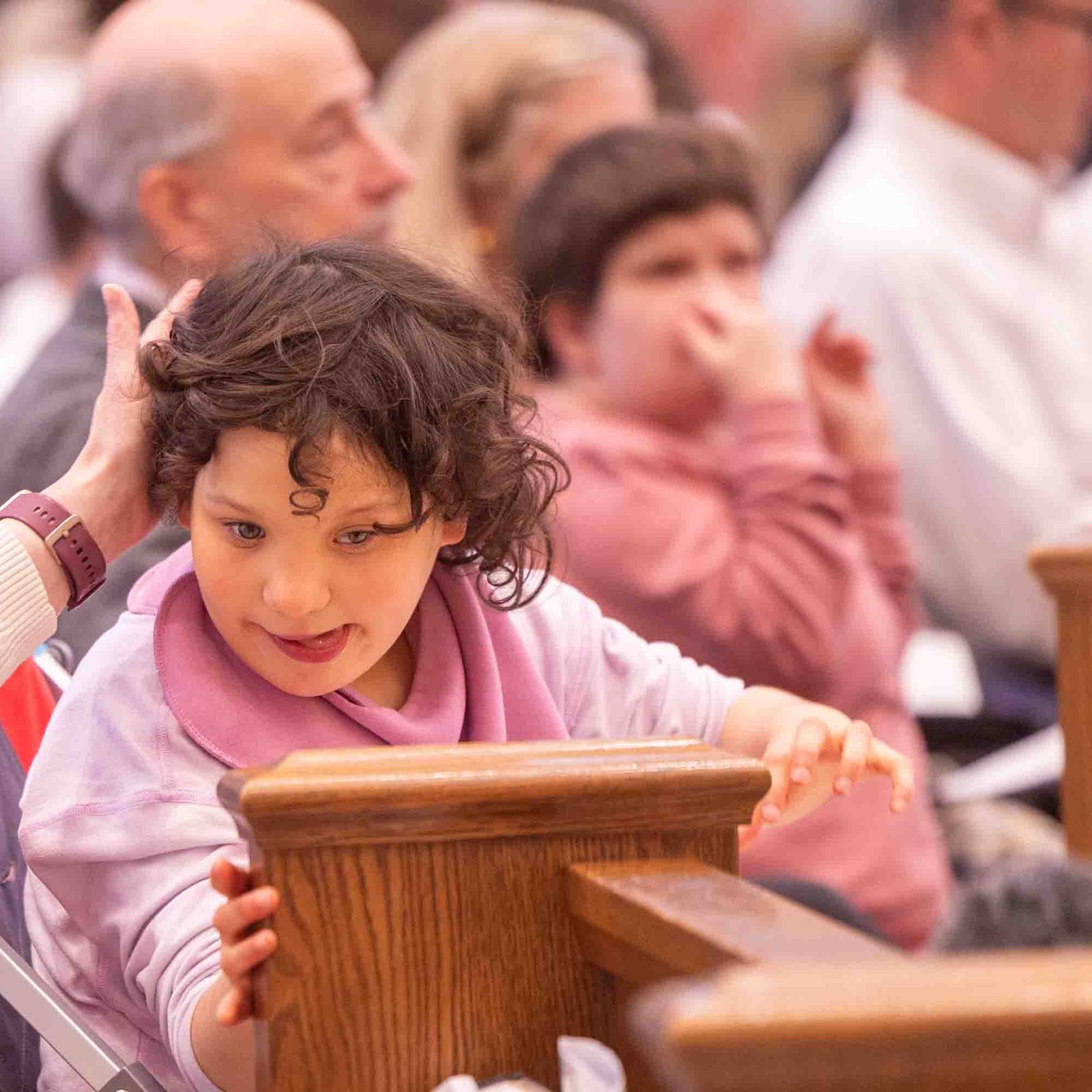 Kristi Hall sits with her daughter, Teresa, during the Archdiocese of Washington’s annual White Mass at Our Lady of Mercy Church in Potomac on Oct. 26. The liturgy celebrated the dignity and gifts of people with disabilities and their families. (Catholic Standard photo by Mihoko Owada.)