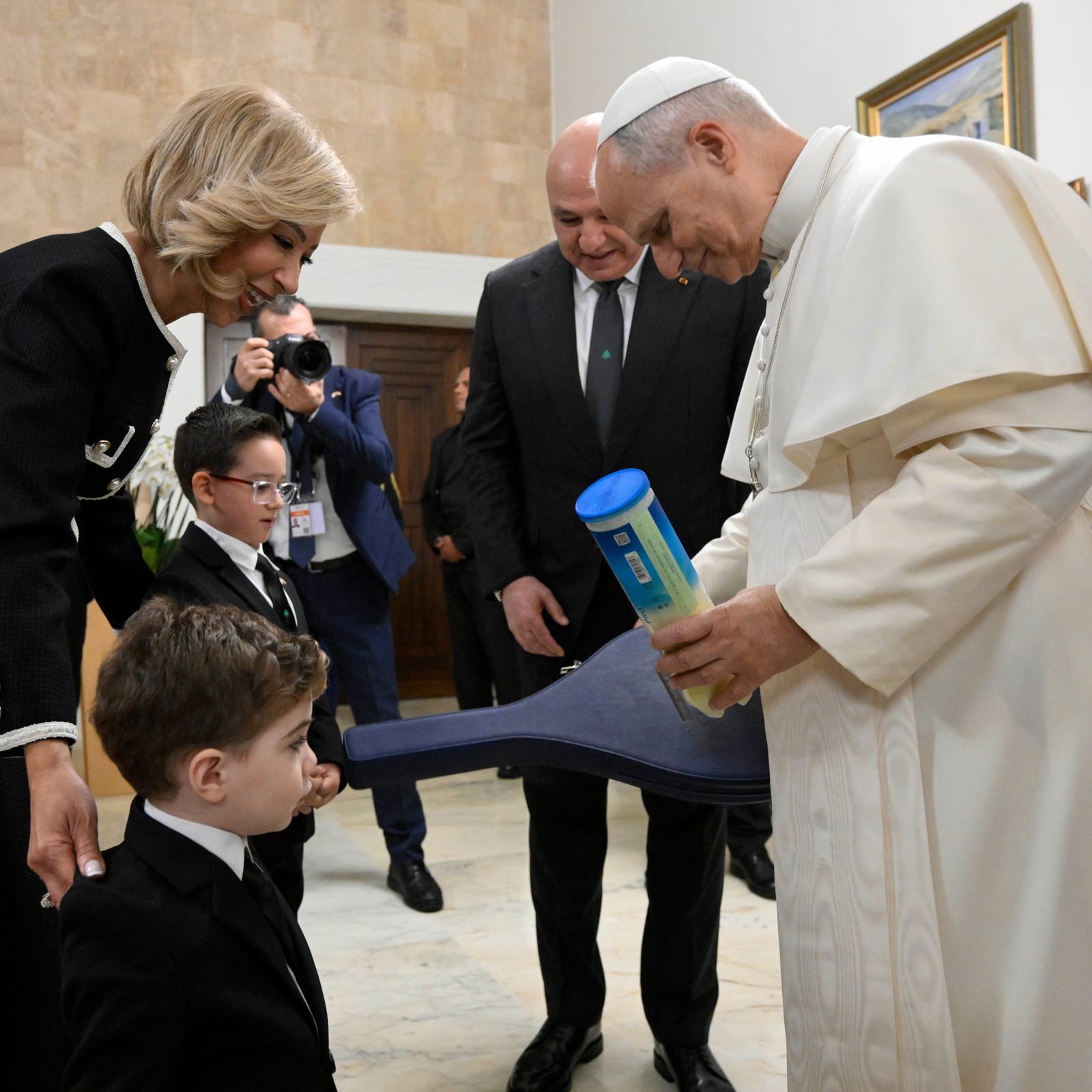 Pope Leo XIV receives a new tennis racket and balls from the grandchildren of Lebanese President Joseph Aoun and his wife, Nehmat Nehmeh, at the presidential palace in Beirut Nov. 30, 2025. (CNS photo/Vatican Media)