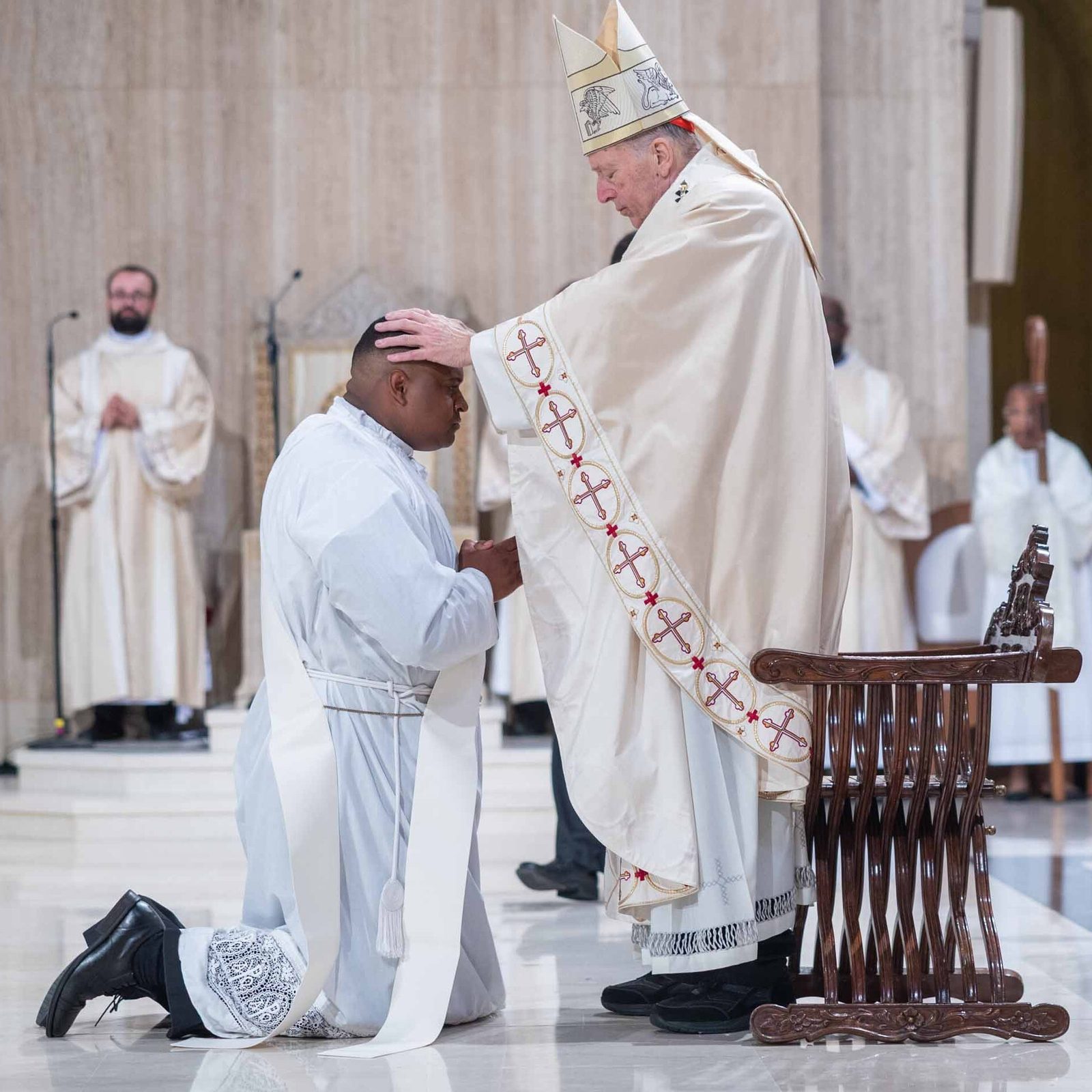 During the Mass of Priesthood Ordination at the National Shrine on June 20, 2026 for the five new priests of the Archdiocese of Washington, Father Jessiah S Rojas is ordained to the priesthood by Cardinal Robert W. McElroy. (Catholic Standard photo by Mihoko Owada)